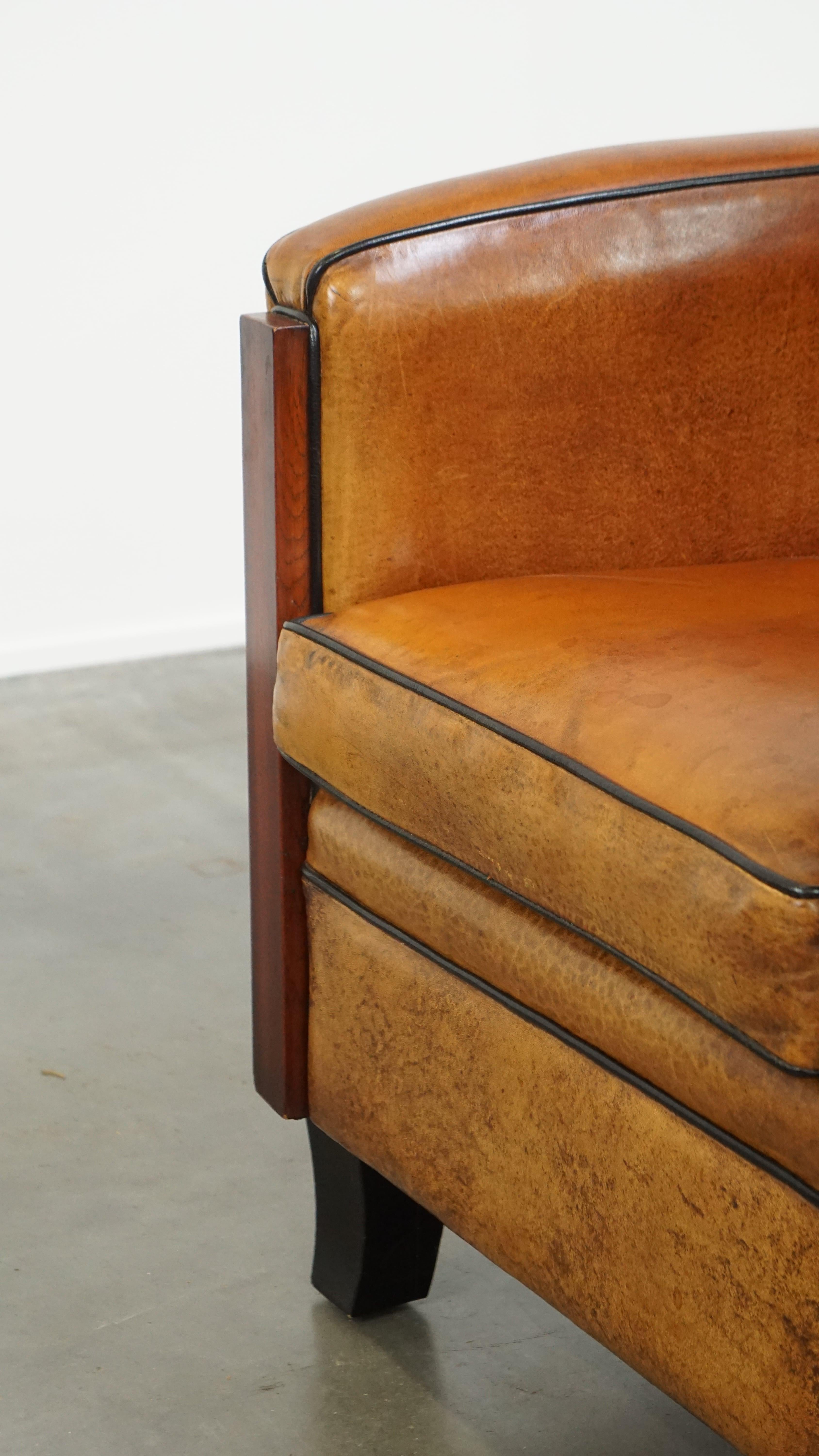 Sheepskin Art Deco design armchair with gorgeous wooden details and black piping For Sale 8