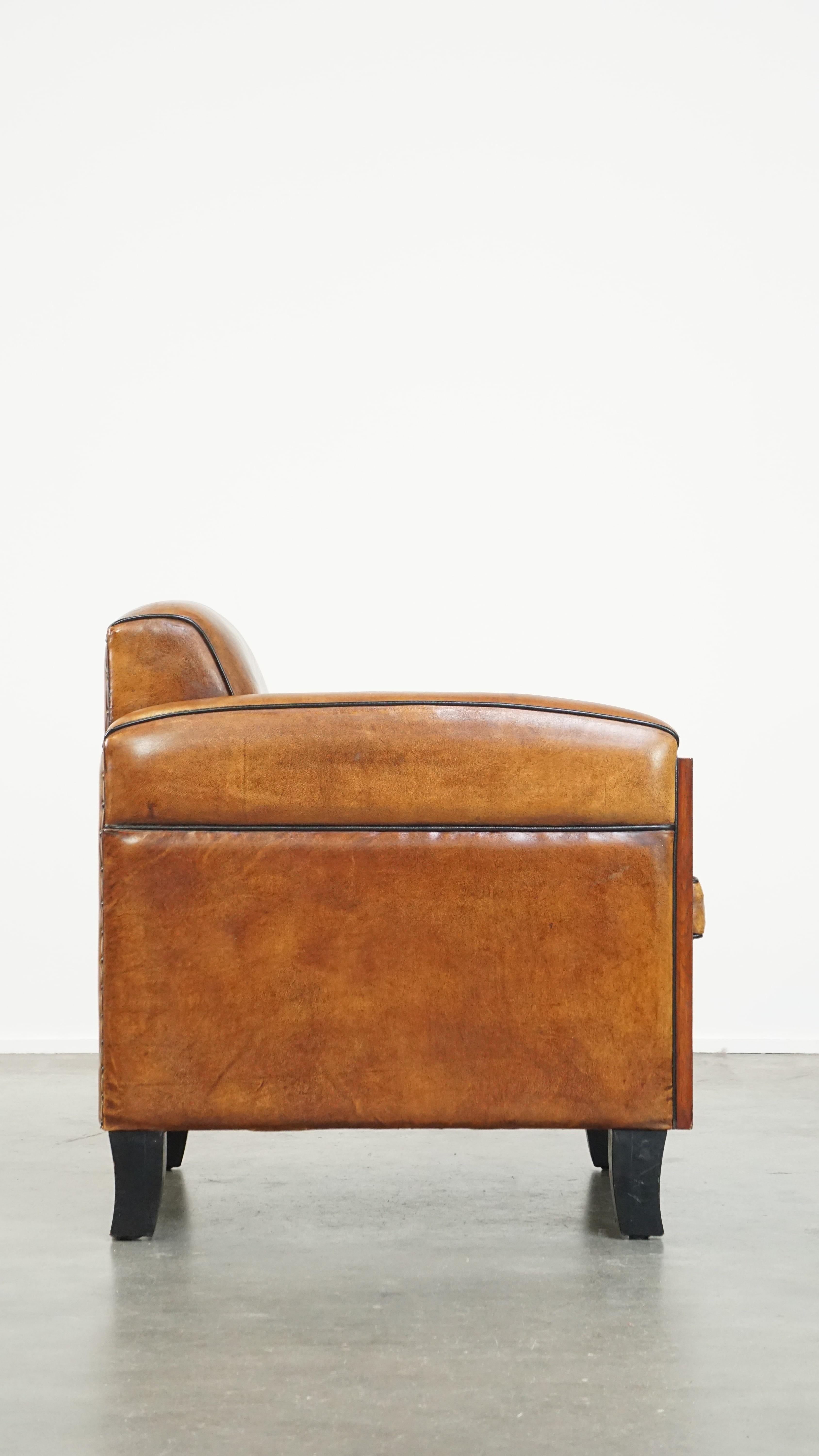 Hand-Crafted Sheepskin Art Deco design armchair with gorgeous wooden details and black piping For Sale