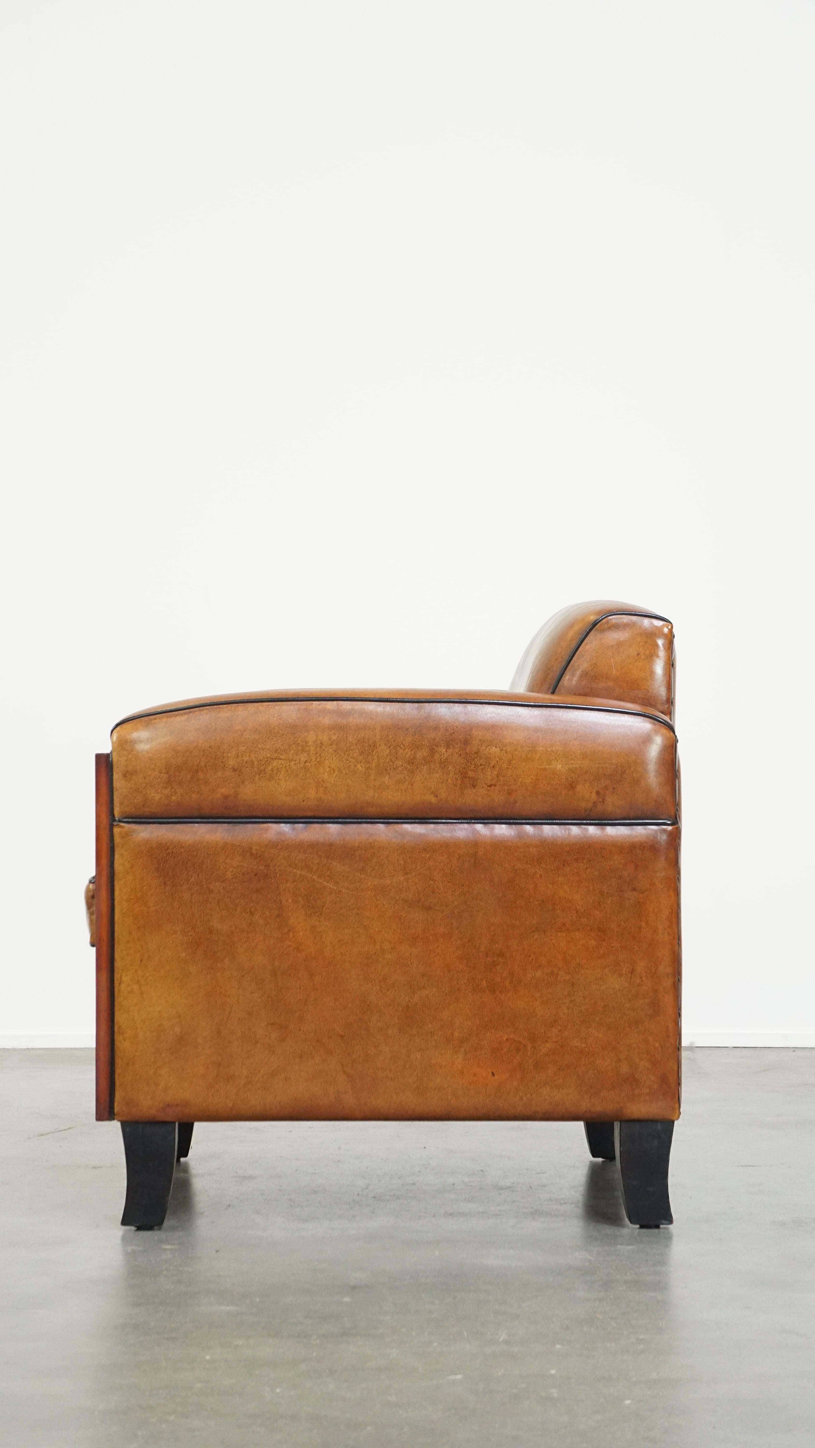 20th Century Sheepskin Art Deco design armchair with gorgeous wooden details and black piping For Sale