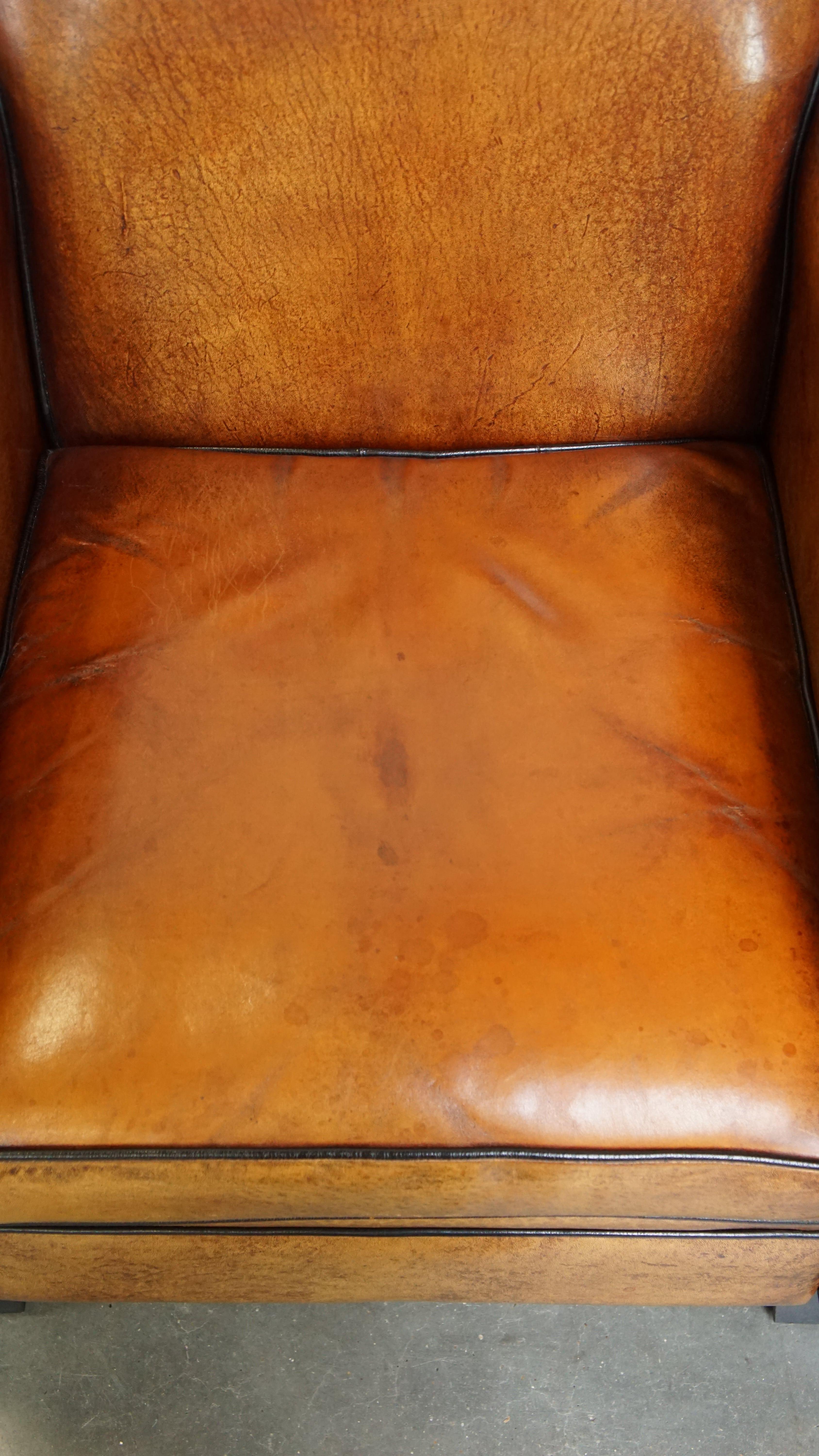 Sheepskin Art Deco design armchair with gorgeous wooden details and black piping For Sale 1