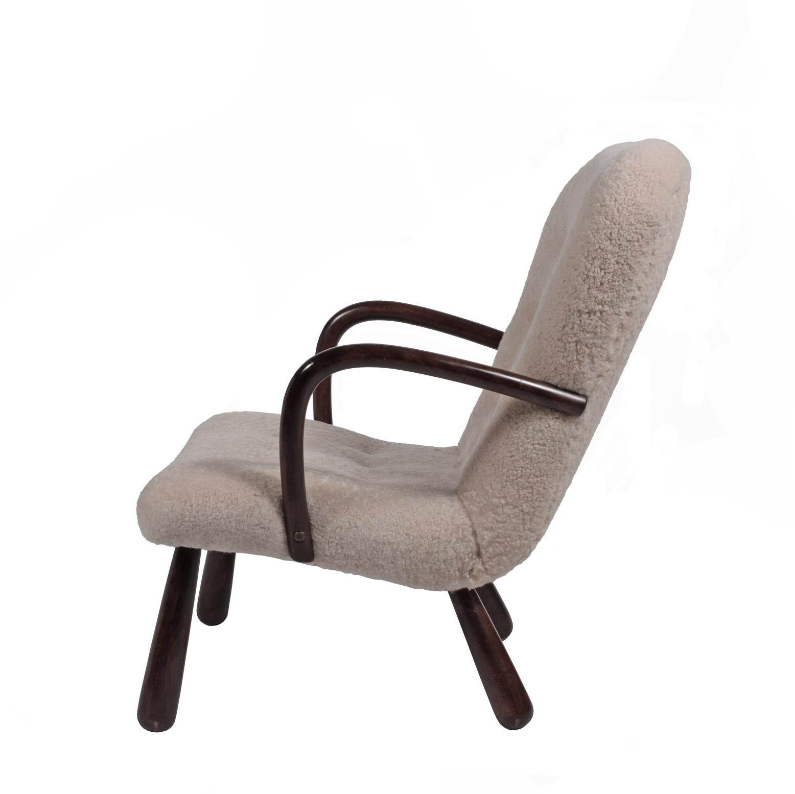 Stained Beachwood lounge chair with club shaped legs and curved armrests. This model was produced in the 1950s by Ikea named 'Åke' and has been attributed to Philip Arctander.
