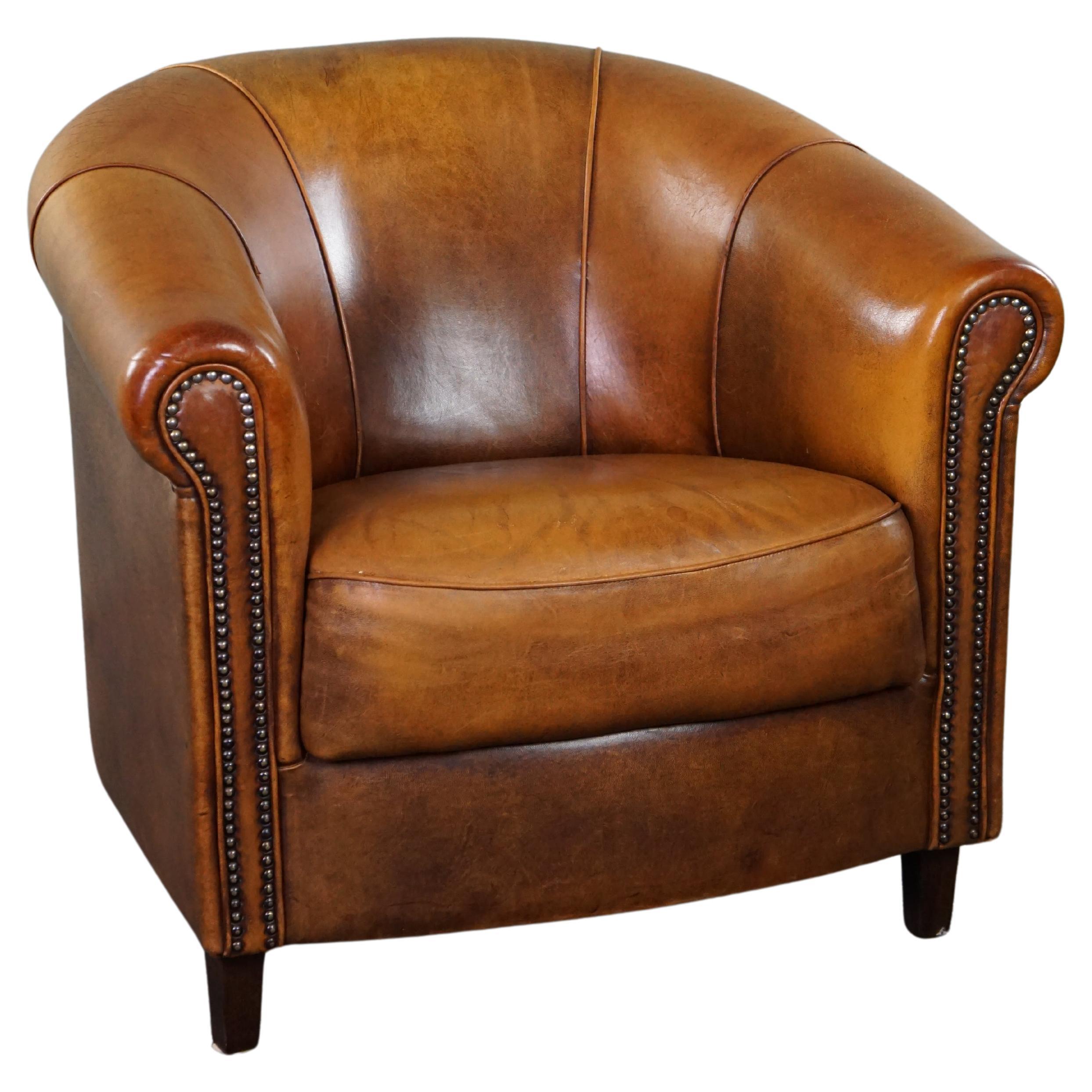 Sheepskin club armchair with a fixed seat cushion For Sale