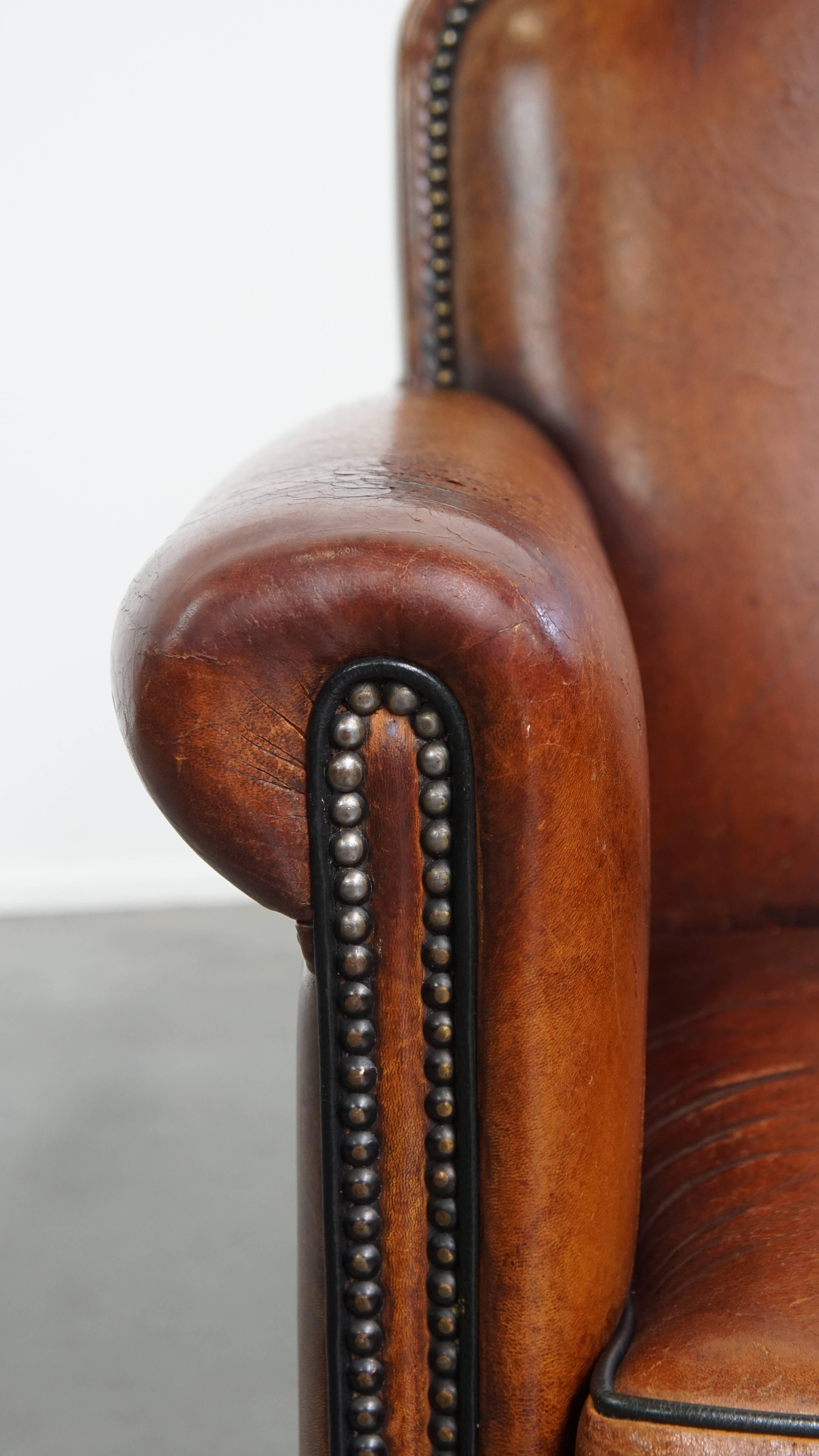 Sheepskin leather armchair in a cognac color with black piping For Sale 3
