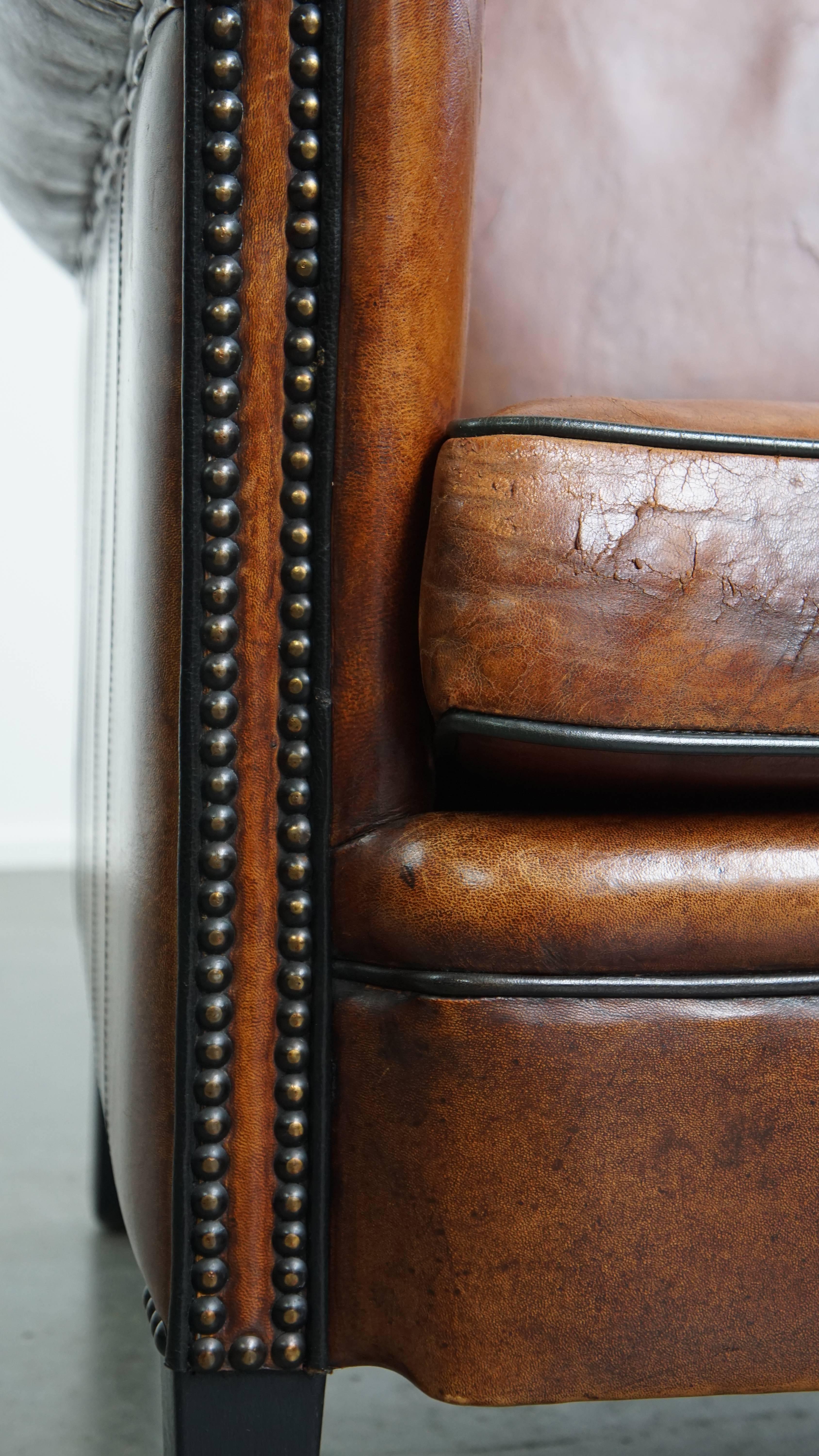Sheepskin leather armchair in a cognac color with black piping For Sale 4