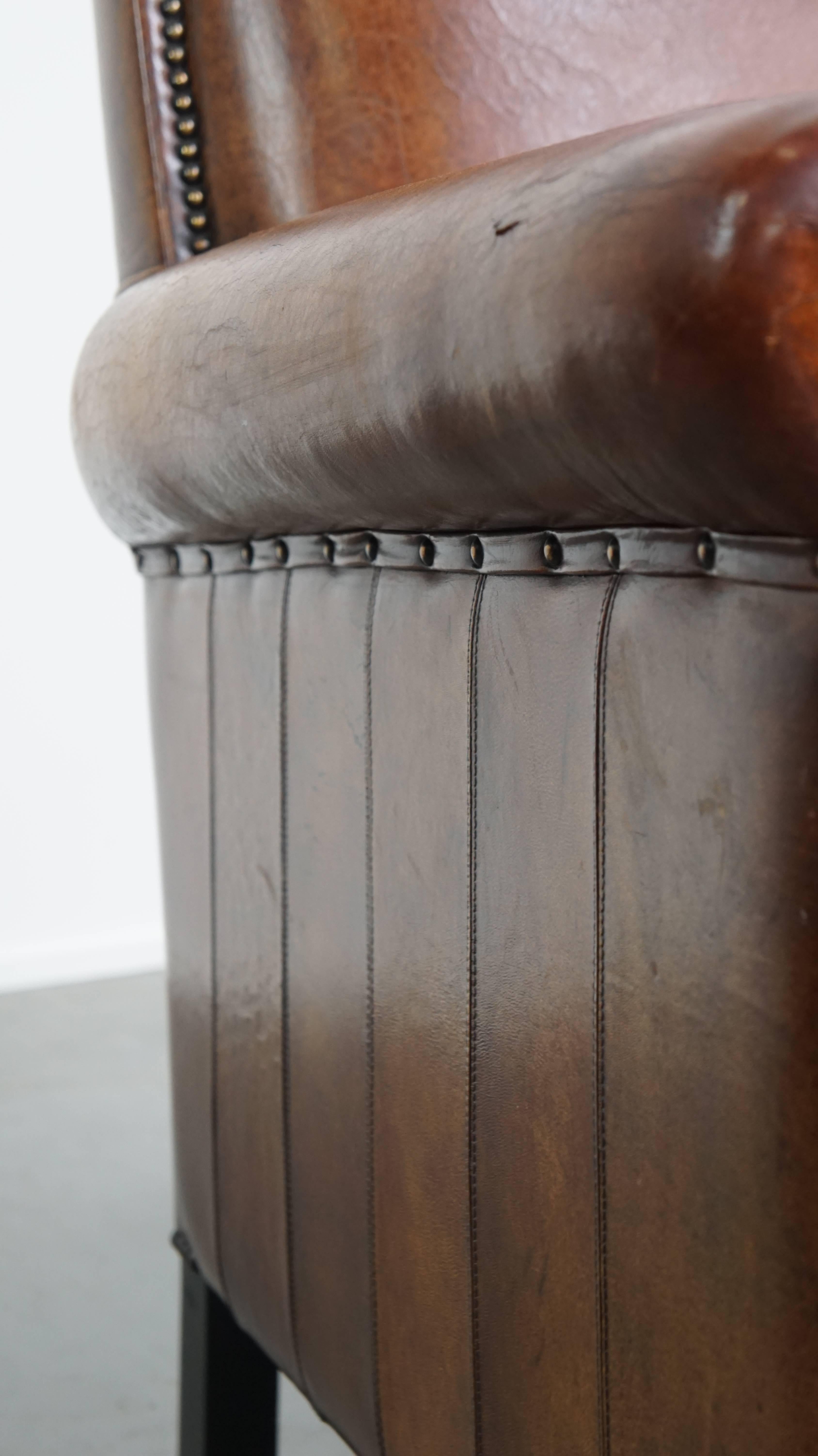 Sheepskin leather armchair in a cognac color with black piping For Sale 5