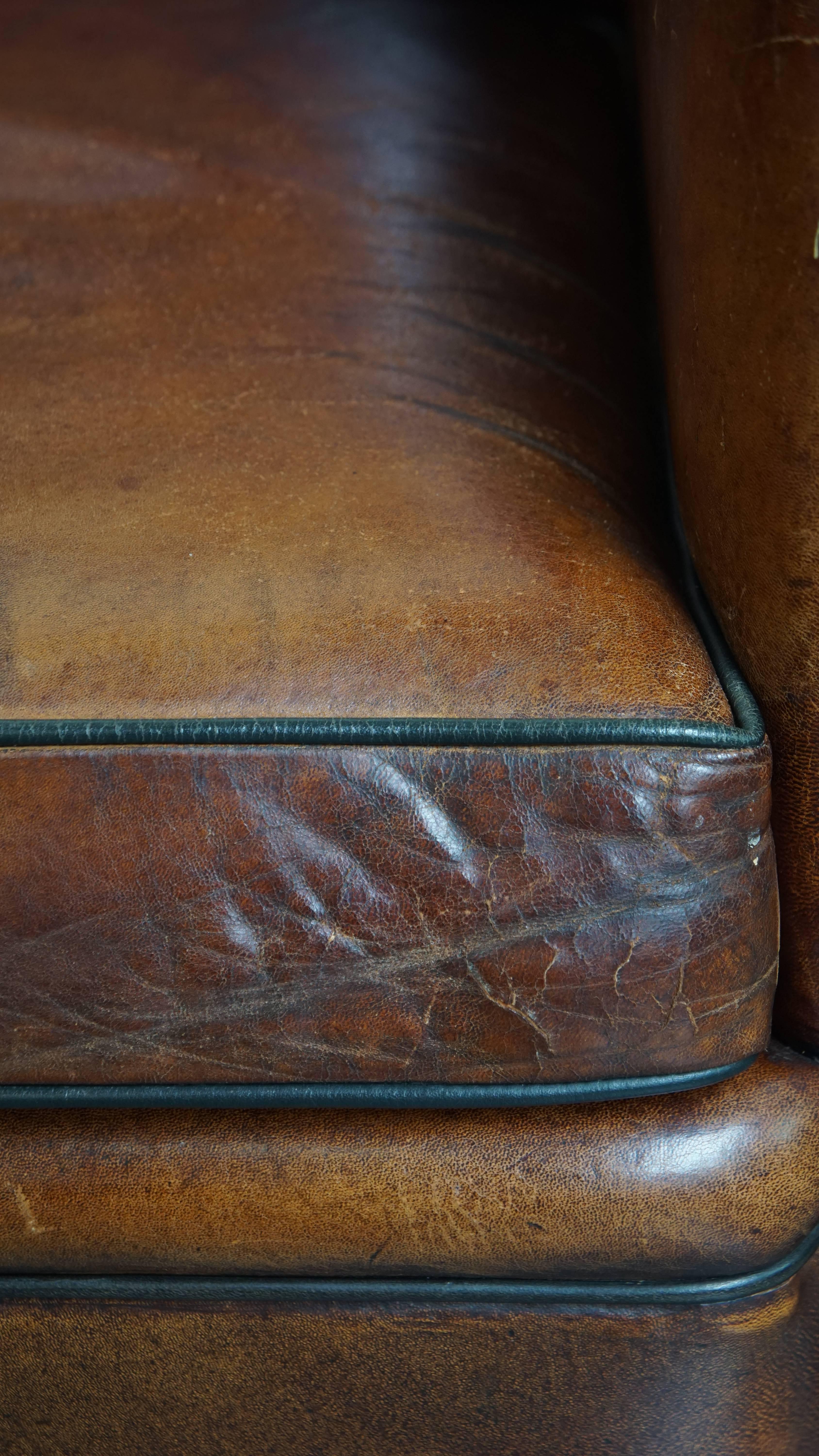 Sheepskin leather armchair in a cognac color with black piping For Sale 6