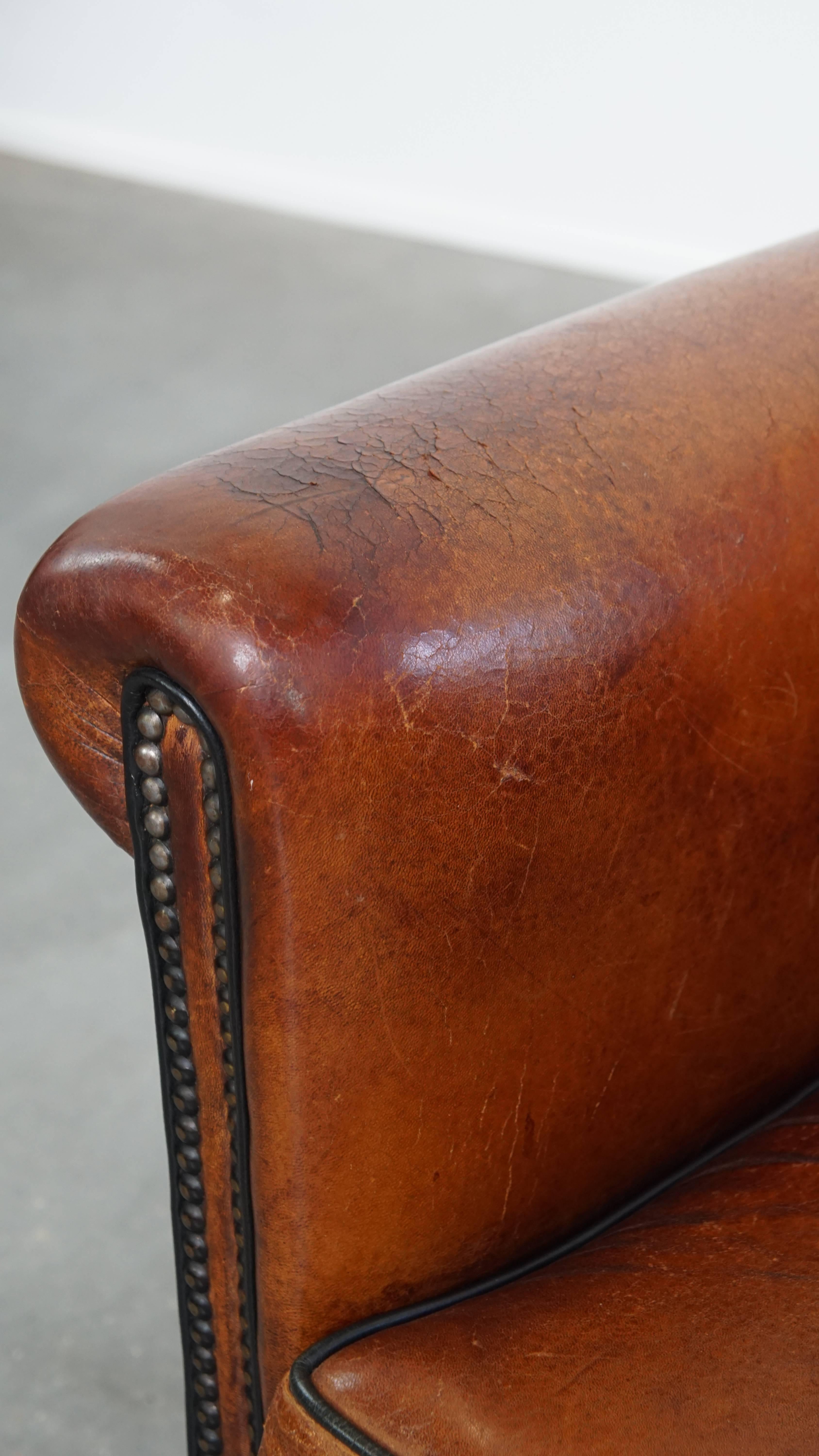 Sheepskin leather armchair in a cognac color with black piping For Sale 8