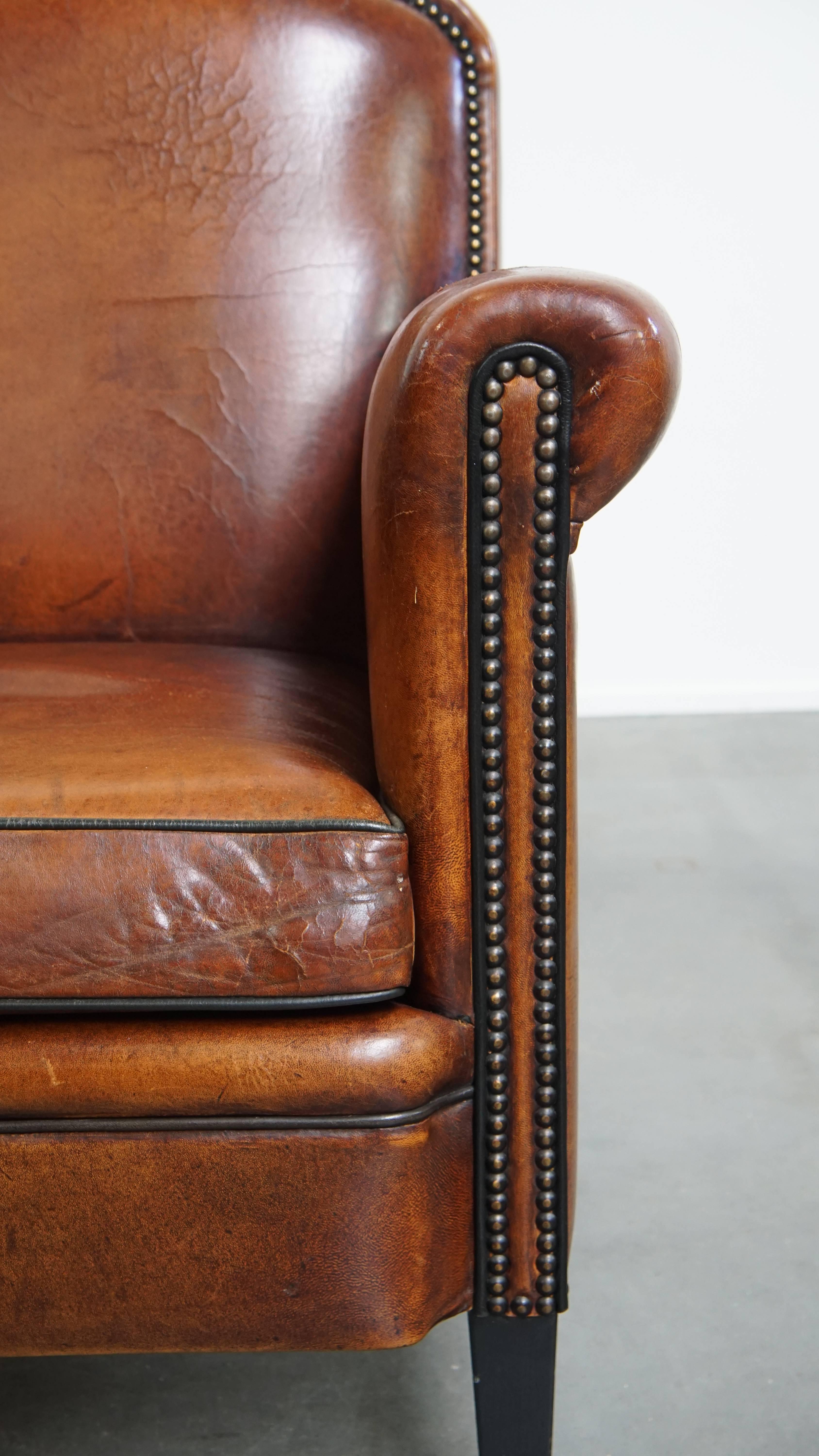 Sheepskin leather armchair in a cognac color with black piping For Sale 2