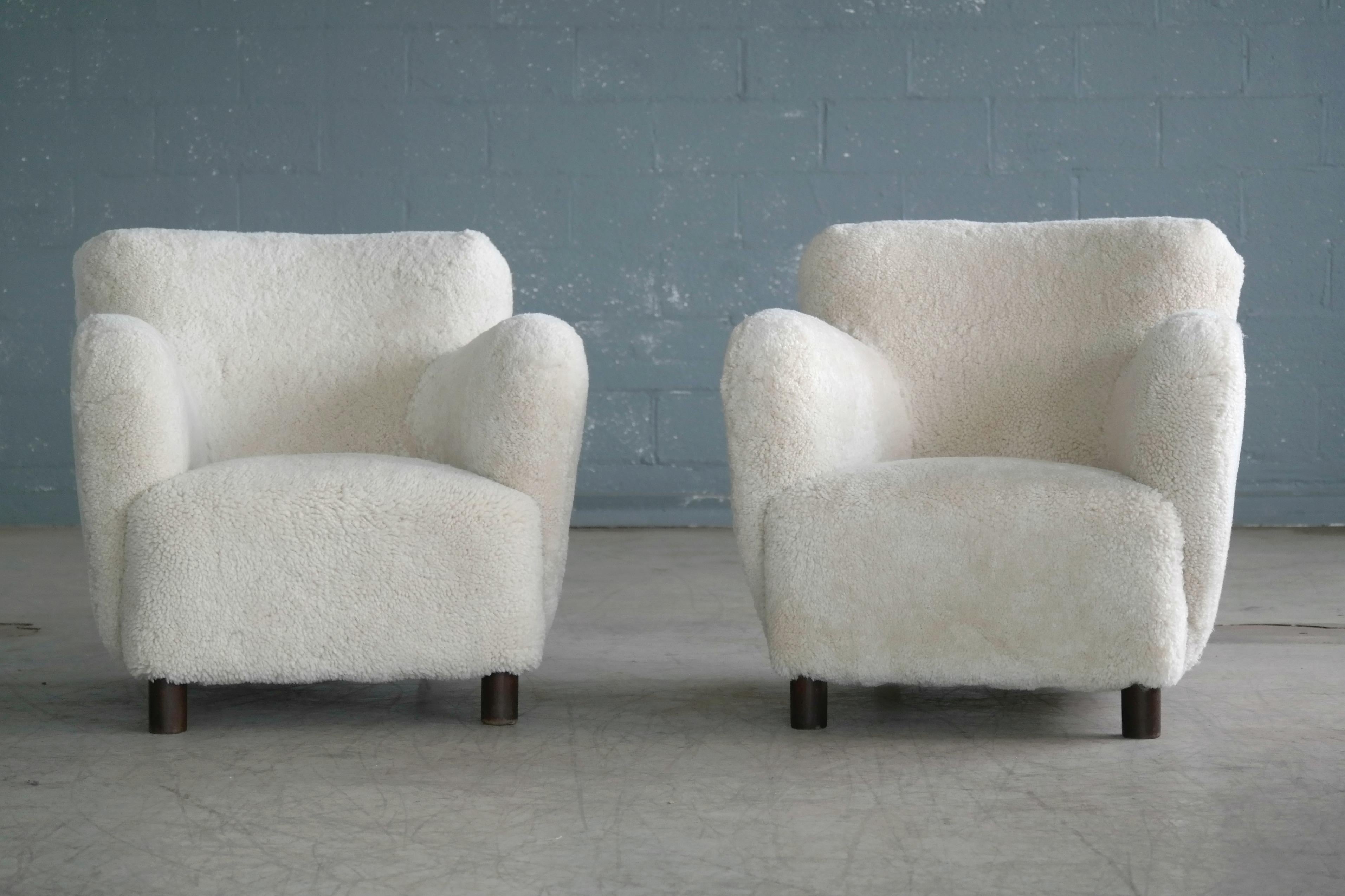 Rare to find Mogens Lassen attributed pair of lowback club or lounge chairs from the 1940s featuring the rounded armrest design and the cylindrical front legs that are very characteristic of Lassen. Lassen's unique style is increasingly coveted and