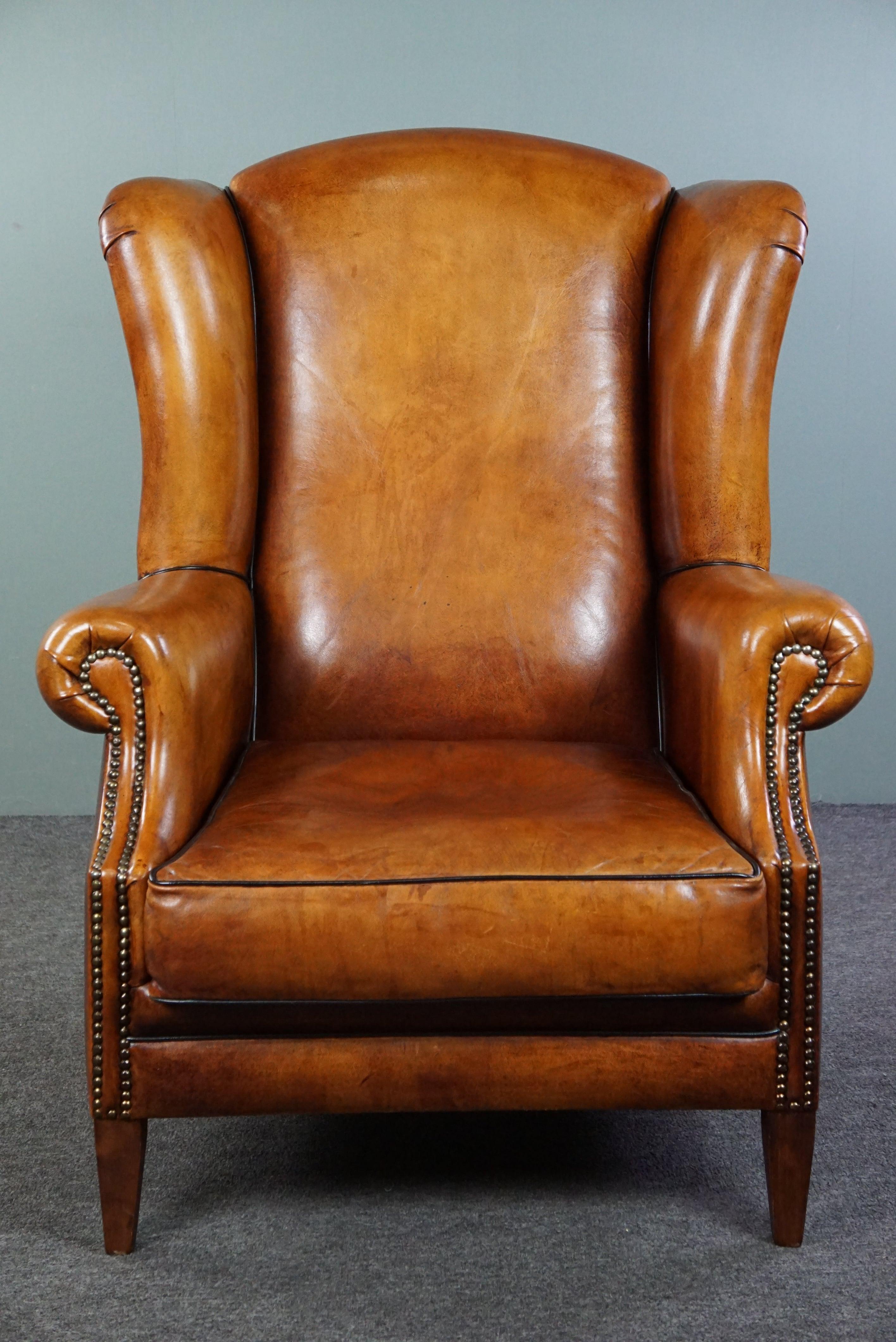 Offered is this very warm sheepskin chair, finished all around with black piping, giving the chair both a timeless and chic look. The minimalist design enhances the incredibly beautiful sheepskin leather. The seat of this chair is very comfortable,