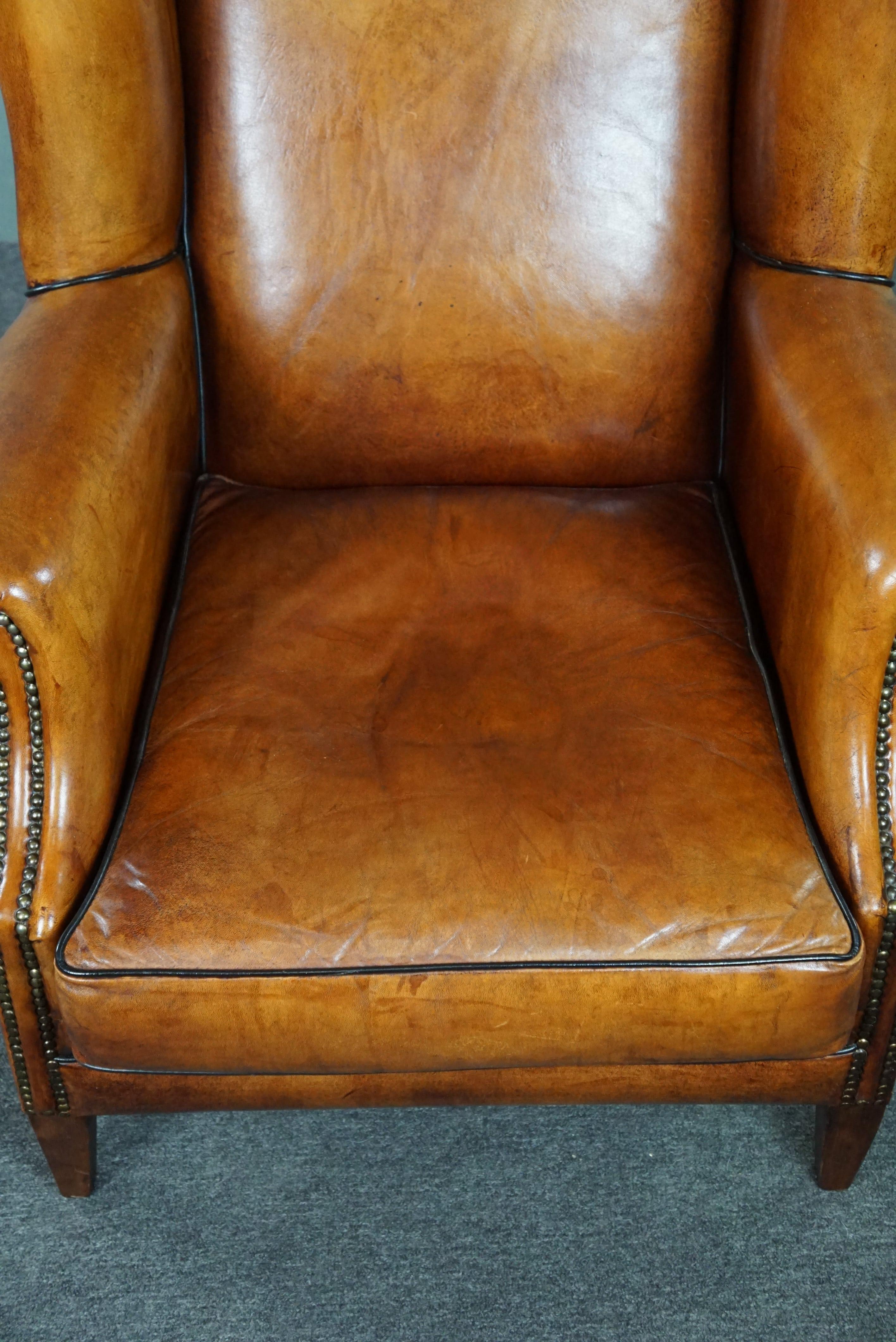 Sheepskin wingback chair with black piping For Sale 1
