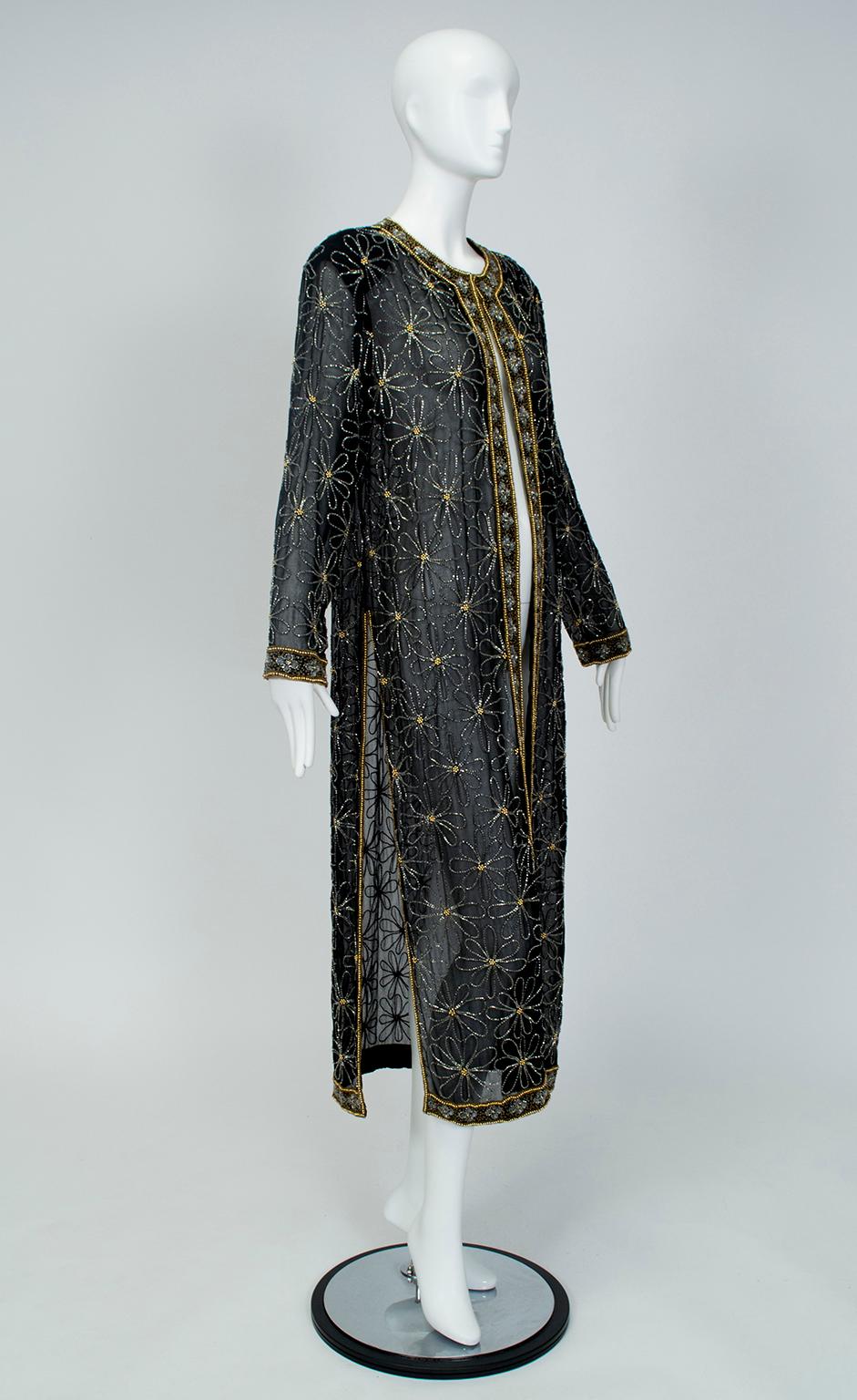 Halfway between a kaftan and a maxi coat, this sheer topper makes up in glamour what it lacks in warmth. The repeating floral pattern consists of clear bugle beads that catch and reflect light, while the hollow gold balls at each flower's center