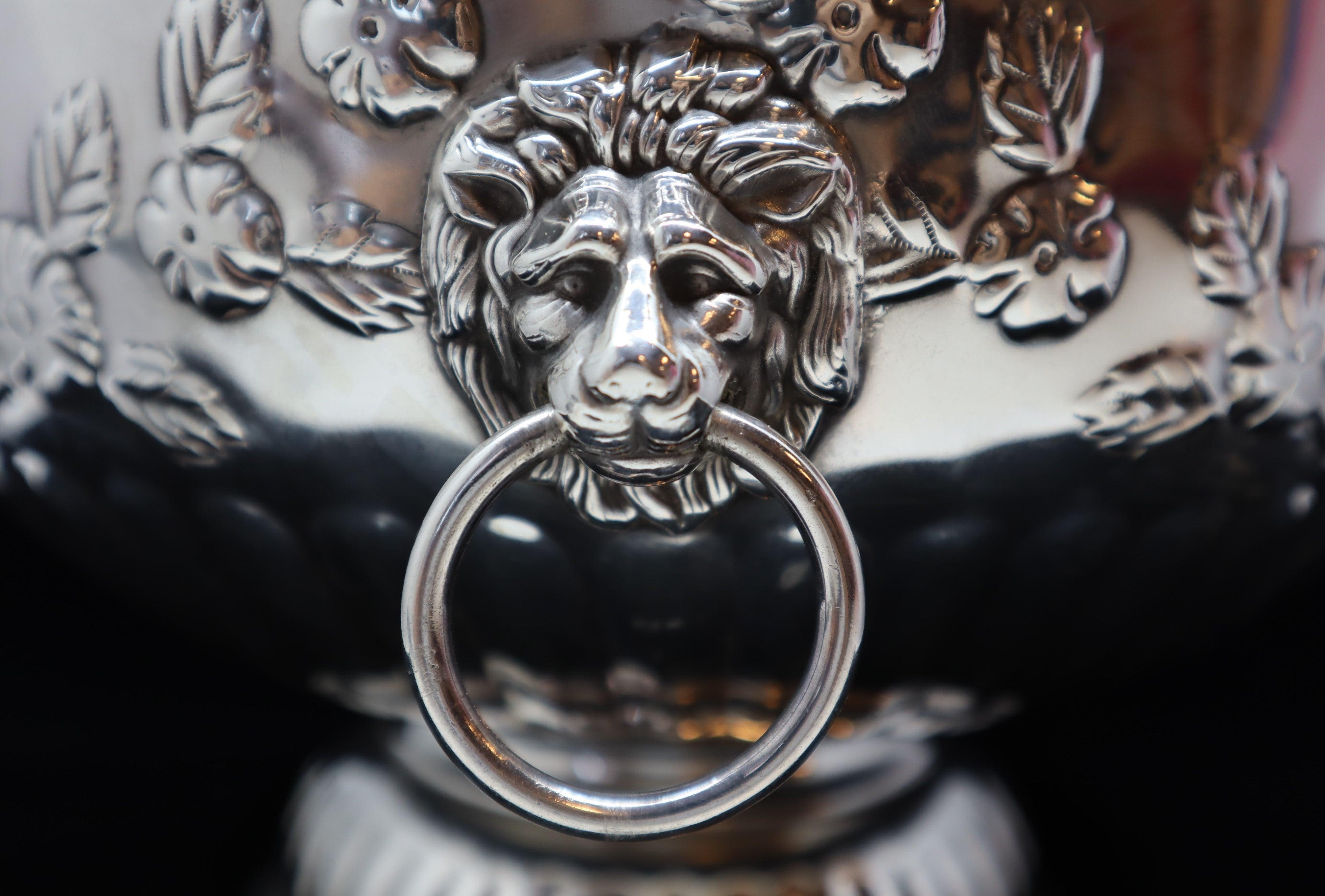 A Sheffield made mid-20th century silver plated punch bowl with lion heads serving as handles.
The silver plate on a copper base.
Hallmarked on the bottom of the base for “Silver on Copper”, Sheffield.
This punch bowl makes a very attractive