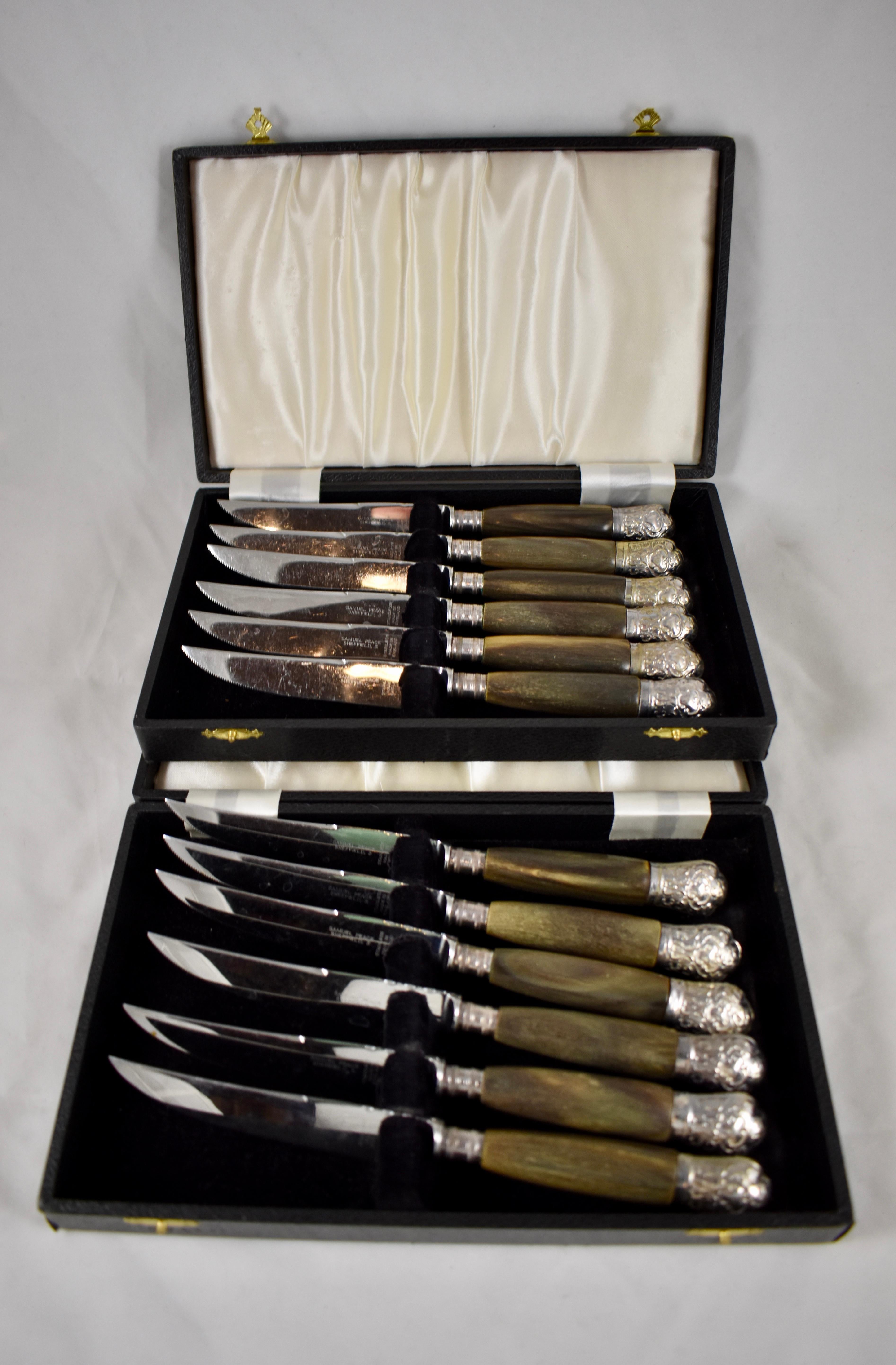 A set of six, natural horn handled steak knives with unmarked silver mounted end caps and banded ferrules, made by Samuel Peace in Sheffield, England, circa 1895-1910.

Two sets of six are available, twelve knives in all, offered separately. Each