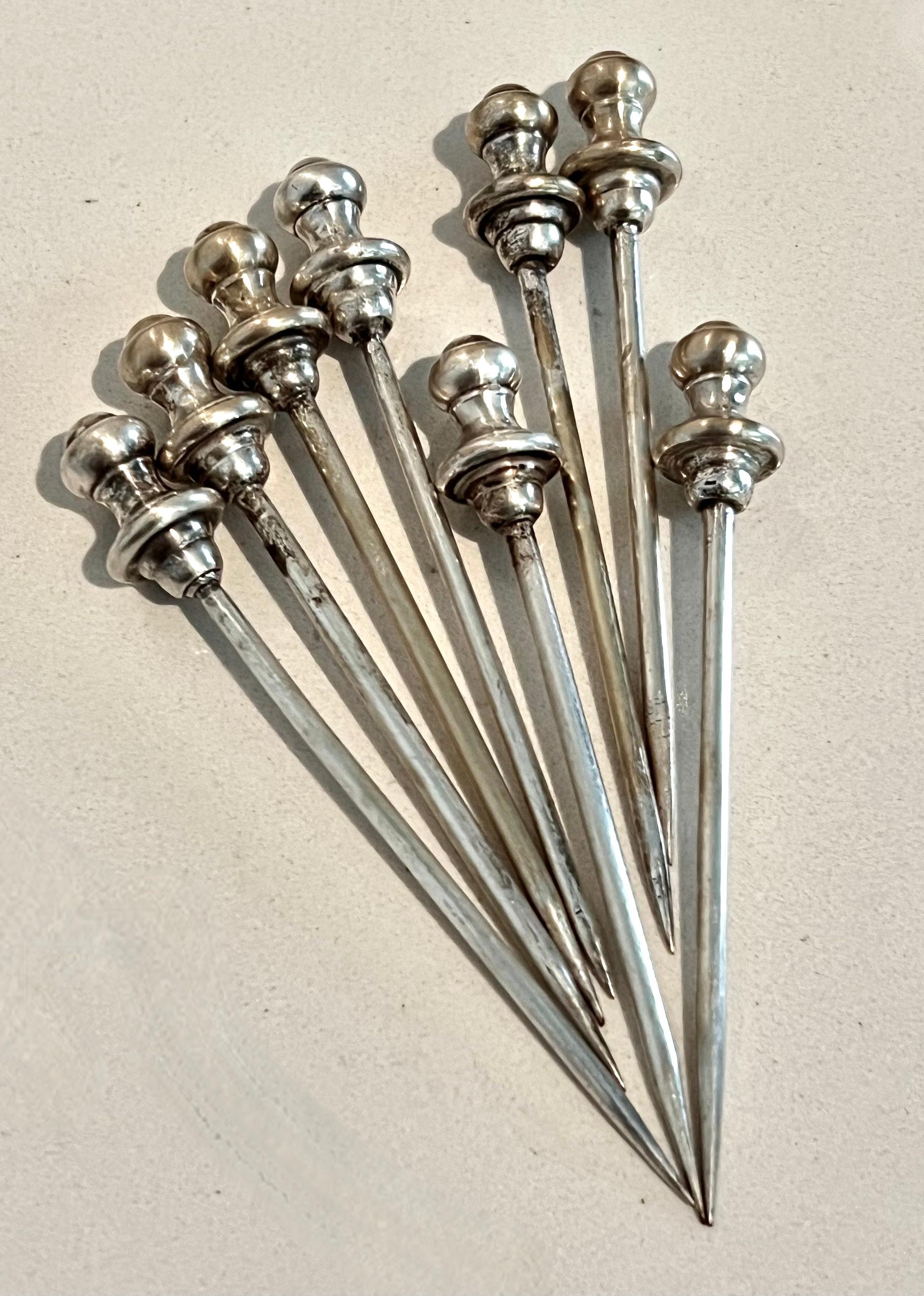 Sheffield silver pick holder with 8 silver plate cocktail picks - a compliment to any bar!

the Sheffield piece is a trophy or urn style holder with small Lions with Rings on either side.  inside are 8 sophisticated silver plate picks.

The set is a