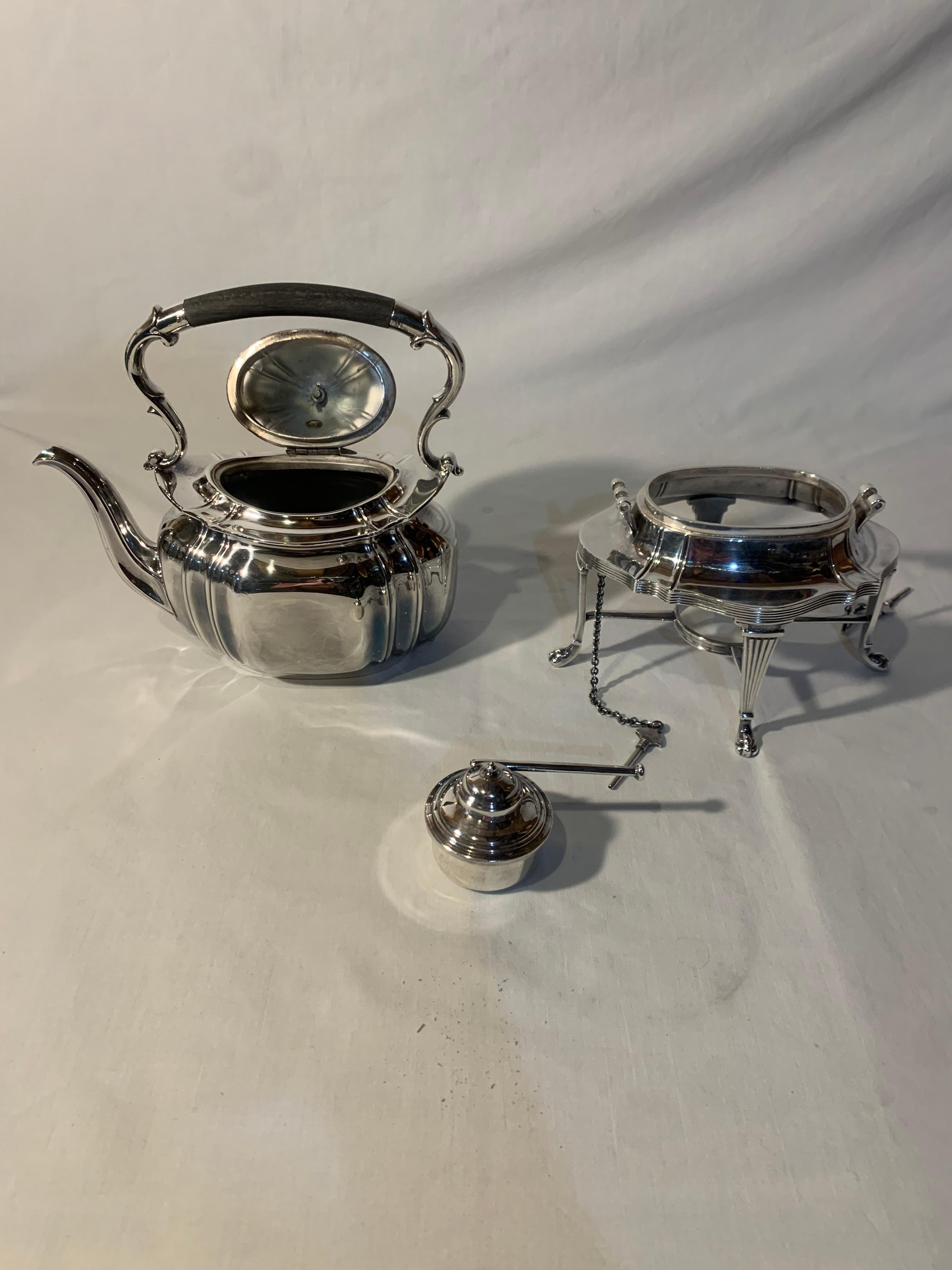 Sheffield silver plate coffee-tea kettle on stand with burner, in the traditional Georgian style Silver Plate. Made in England. Hand Soldered. Insulated handle is genuine ebony. Piece is in excellent condition. there are no visible repairs or dents.