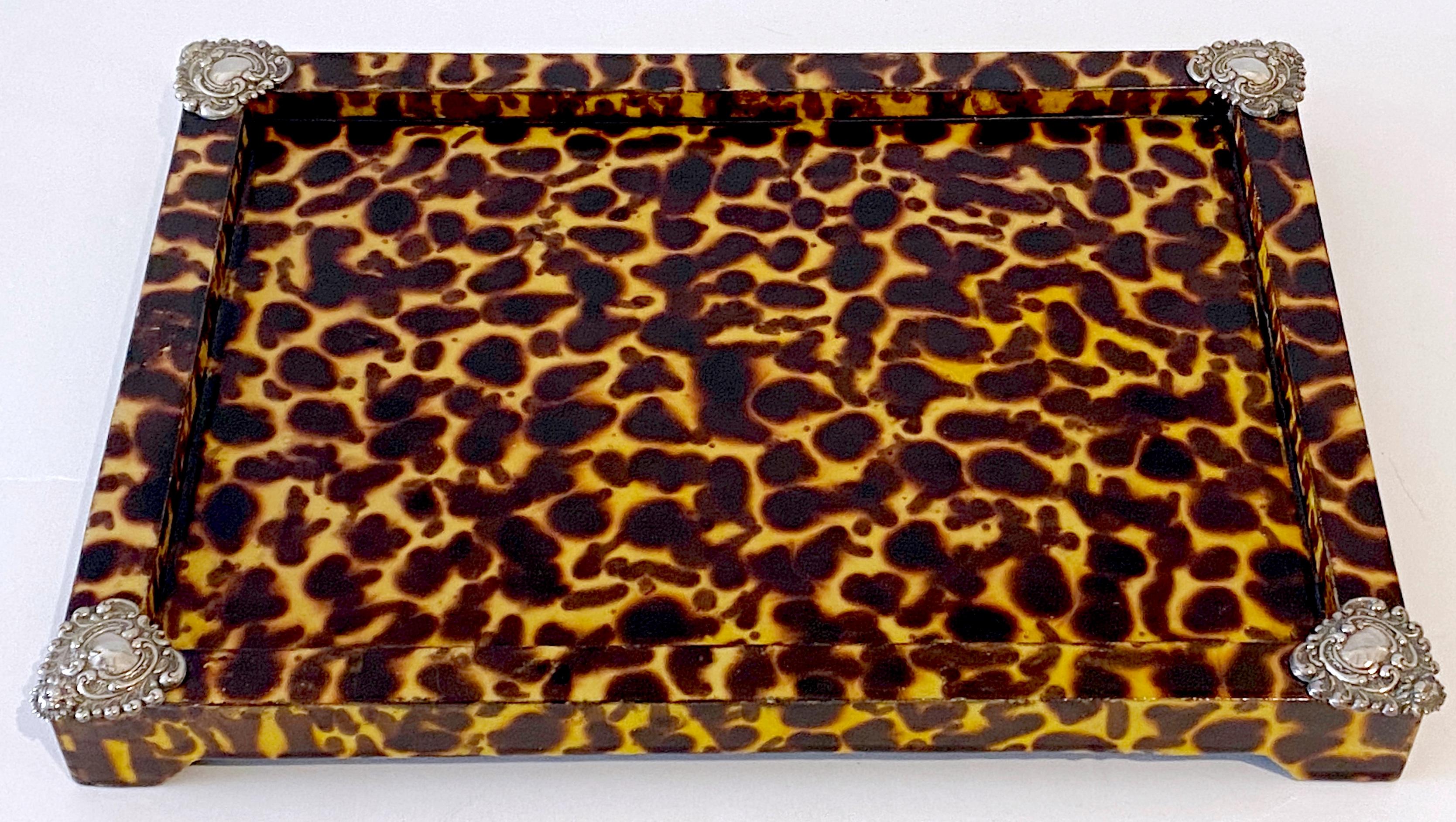 Sheik Sterling Silver Mounted Faux Tortoise Shell Lacquered Tray
European, Later 20th Century 

This later 20th-century European tray is a striking piece, featuring a rectangular form and adorned with sterling silver-mounted heart-shaped repoussé