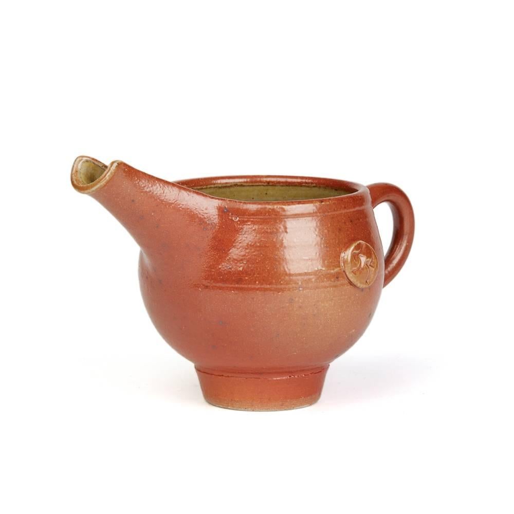A stunning vintage British Studio Pottery dish by renowned potter Sheila Casson and made in Ross-on-Wye. This stylish rounded bulbous stoneware jug stands on a narrow rounded foot with loop handle and with a raised deep channeled pouring spout. The