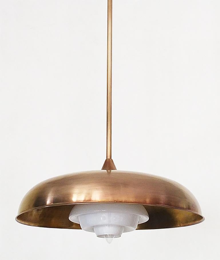 SHEK is a distinctive pendant made of hand spun in solid brass and opal glass shade for down-light.
Finished and assembled by hand by skilled Candas Design artisans. 
SHEK can be customized on request. 

Brass finishes: Aged brass, Black bronze,