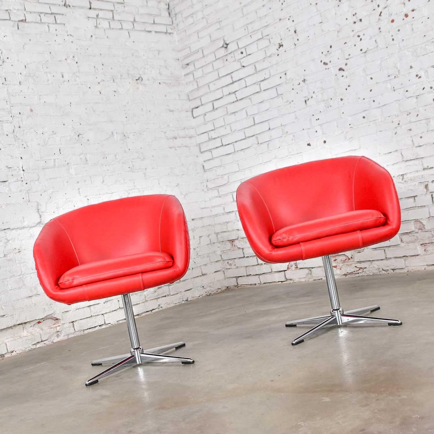 Awesome pair of Shelby Williams Mid-Century Modern swivel bucket chairs with chrome X base. Newly upholstered in bright red vinyl faux leather fabric. In beautiful vintage condition. Sadly, they were tagged when we purchased them, but the