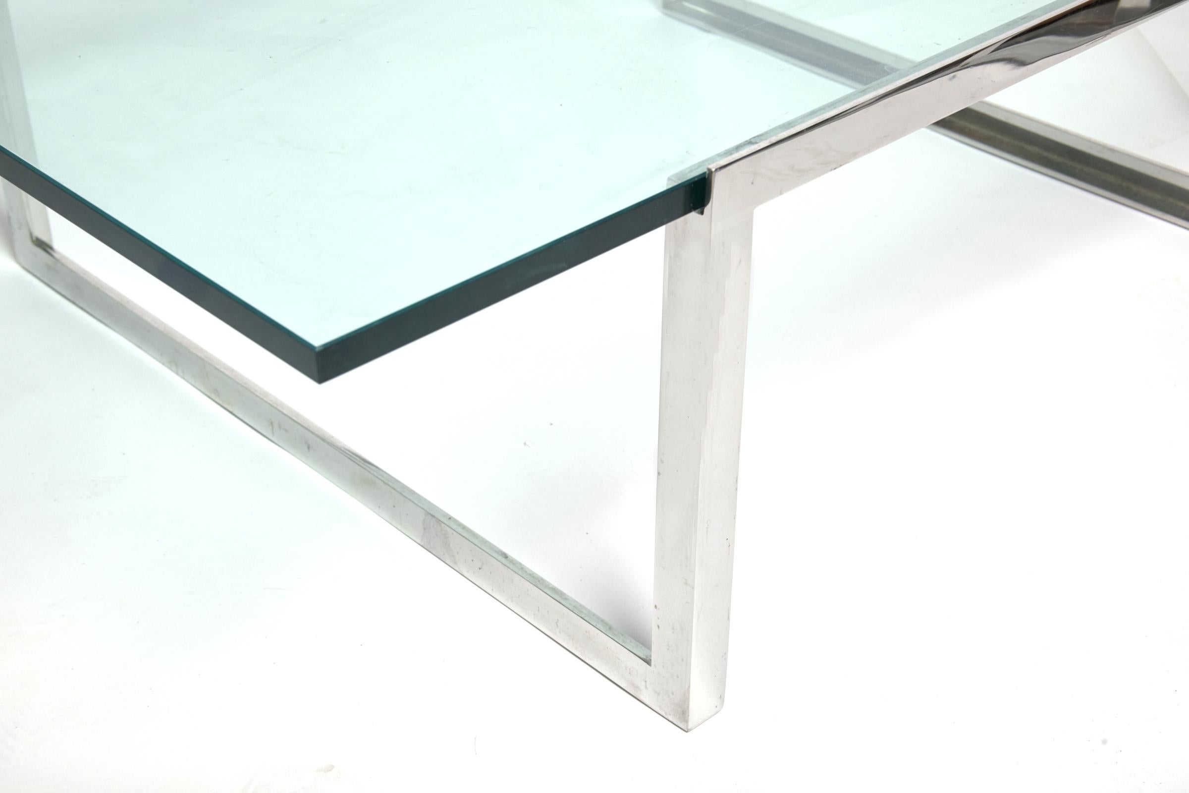 2006 Sheldon, Mindel SM rectangular coffee table for Knoll features a floating glass top supported by a continuous loop stainless base. Condition is excellent without chips. Cracks or surface wear. A sculptural piece which will compliment any