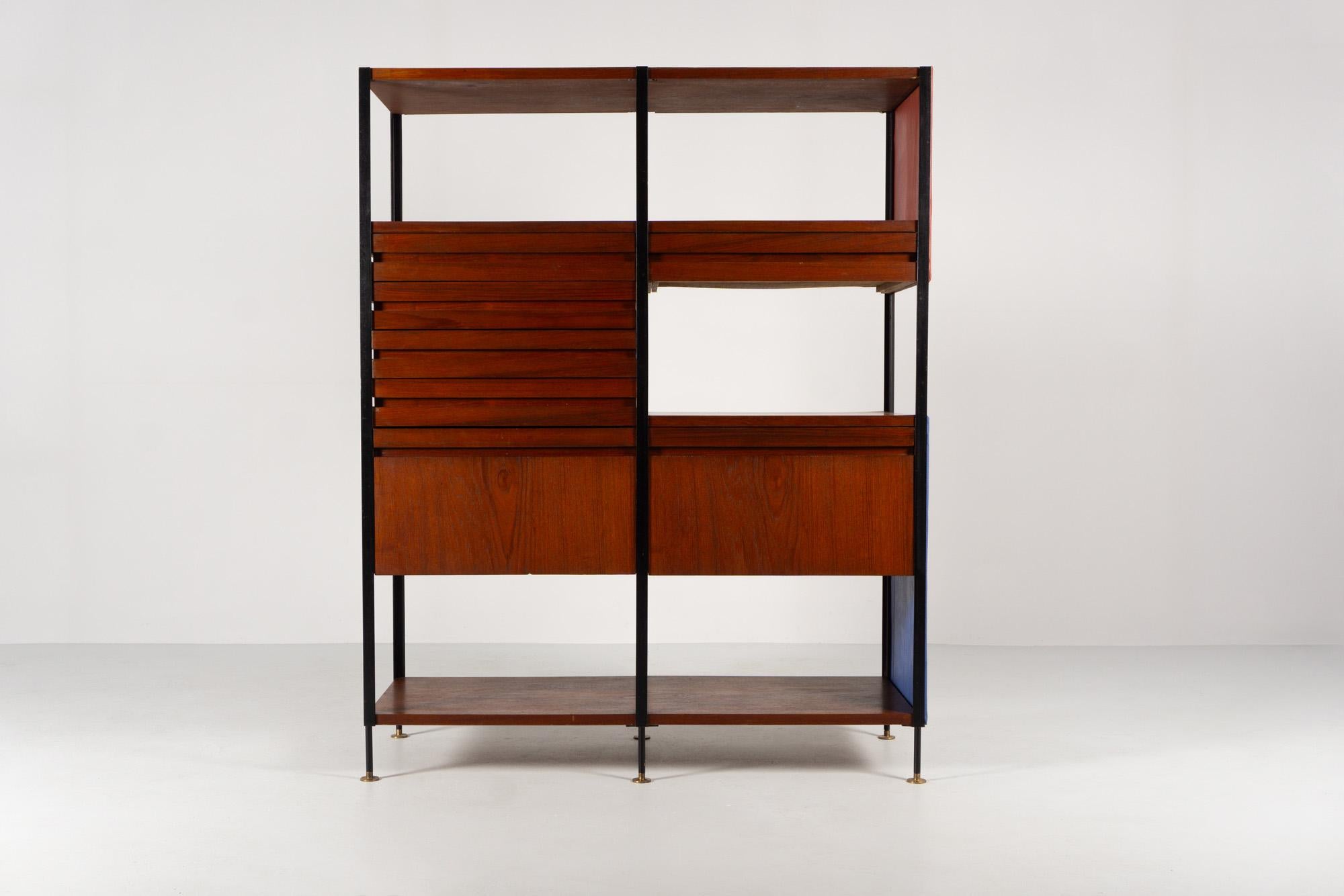 This rare and very functional shelf with drawers and compartments made of teak 
is in the style of the time. Similarities with the design of Charles Eames and Osvaldo Borsani are recognisable.
The design impresses with its light, elegant