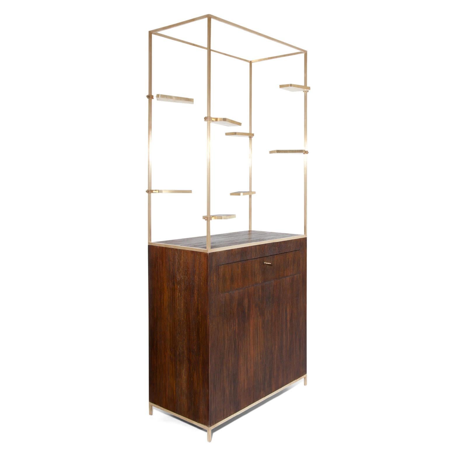 Midcentury shelf-unit out of brass with adjustable short shelves. The base has one drawer and is made out of palm wood.