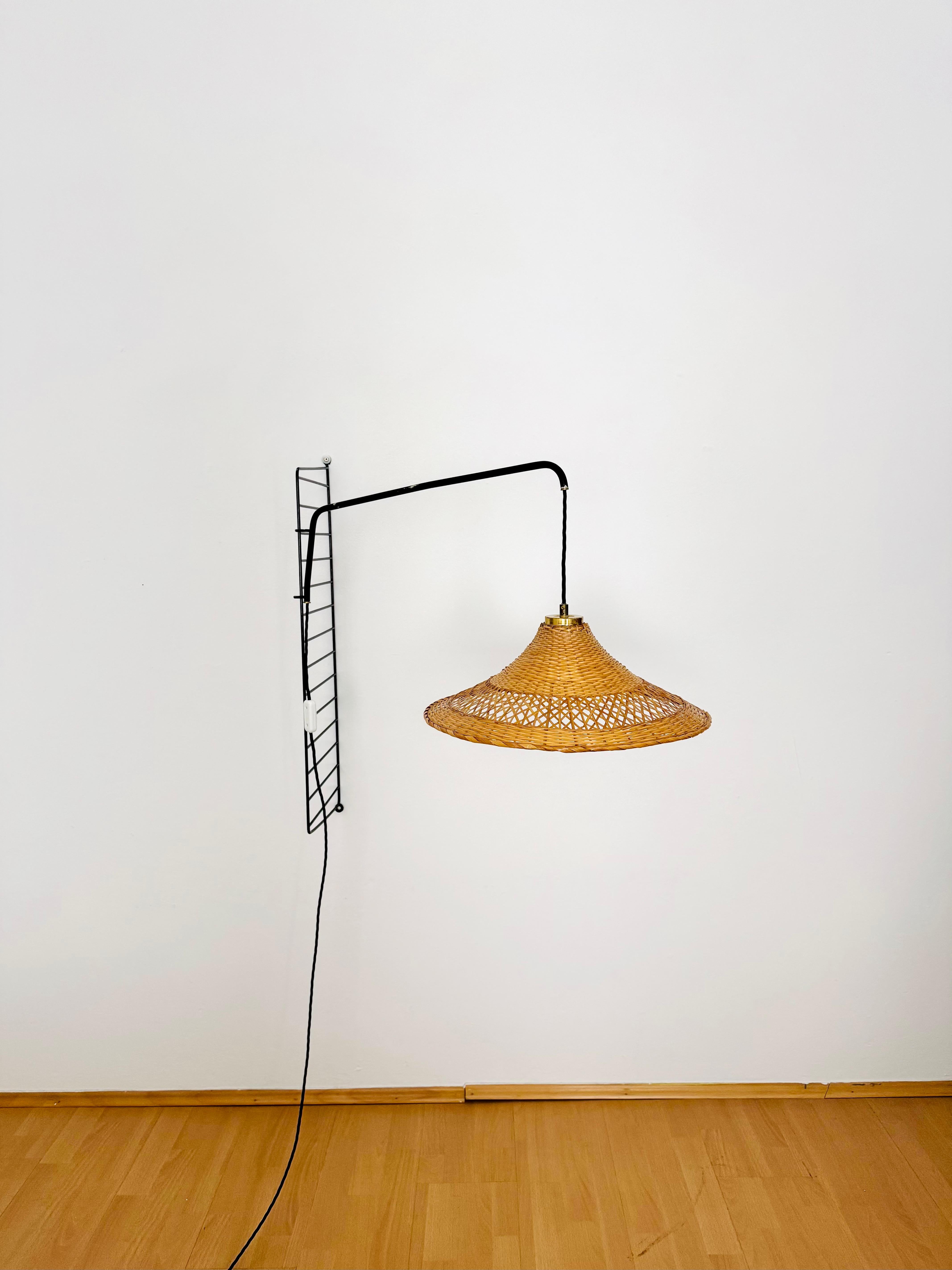 Very rare lamp for string shelves from the 1950s.
Wonderful high -quality workmanship and an absolute favorite.
The lamp can be used as required by the clamp function and is continuously adjustable.
The lampshade made of basket braid spreads a very