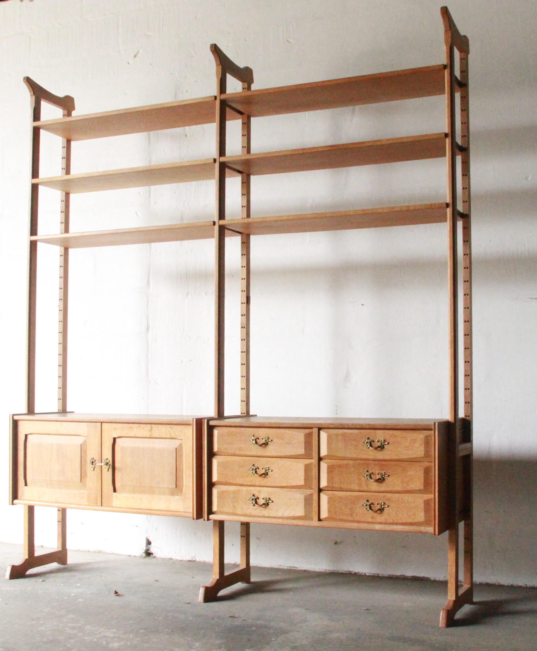 This Danish Solid Oak Room Divider is a vintage modular library bookcase shelf system designed by Henning Kjærnulf in the 1960s. It's in excellent vintage condition with some minor wear marks, which is typical for vintage items. The free-standing
