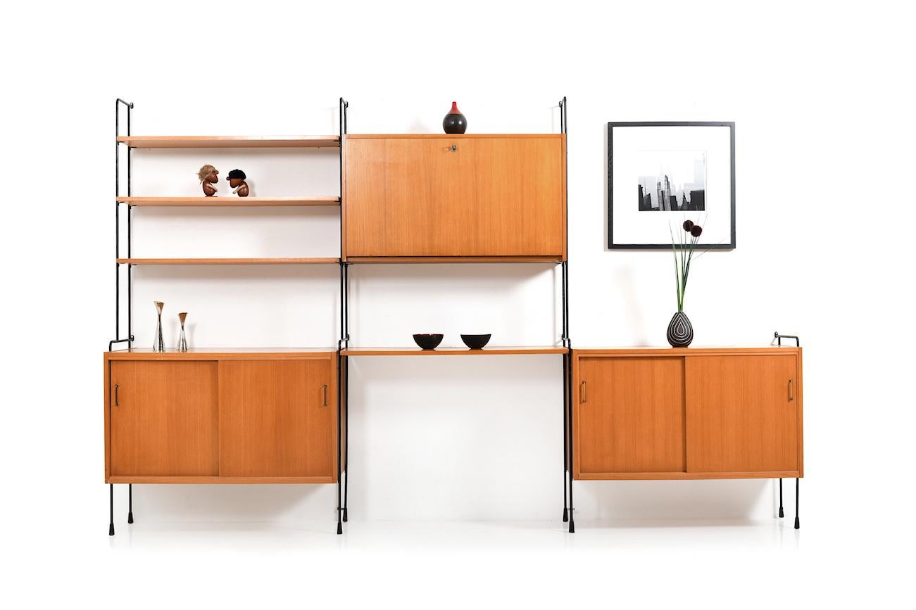 Plenty of room to store this very well designed shelving system. Design by Ernst Dieter Hilker for Hilker. The Omnia range has the possibility of placing the cabinets and shelves freely. The system consists of 3 cabinets (one of these a bar