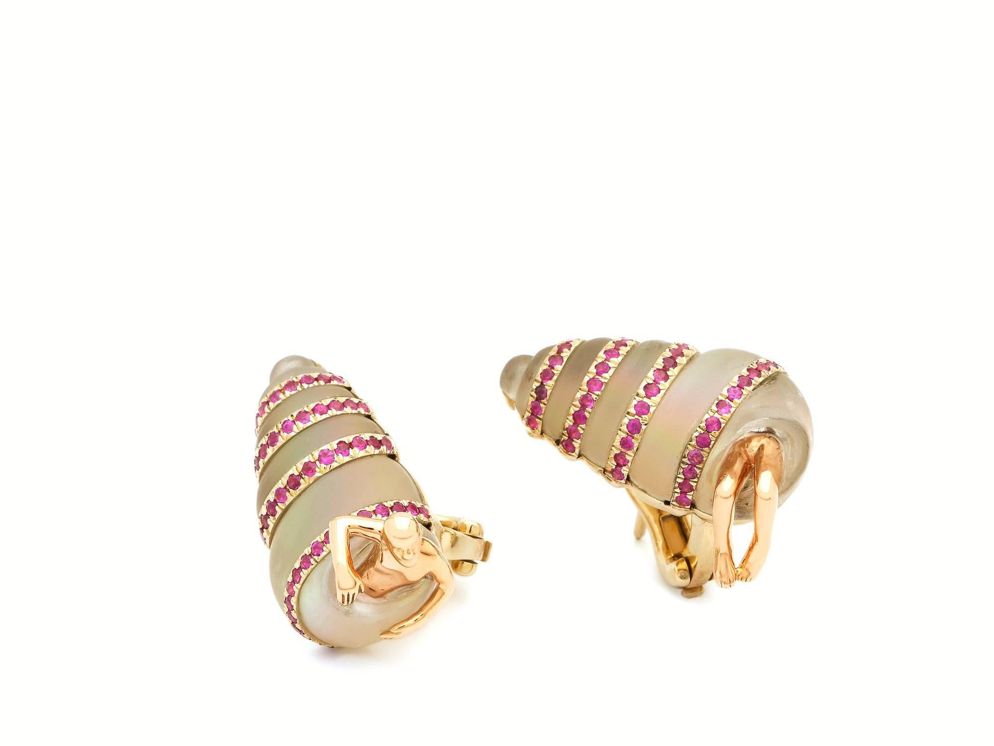 The Shell Earrings, by Bibi van der Velden, are part of the Sea Creatures Collection. The earrings are made of 18k Rose and White Gold, with hand-carved matte Rock Crystal, with a base of Mother of Pearl, and in-laid with vibrant Pink Sapphires. The