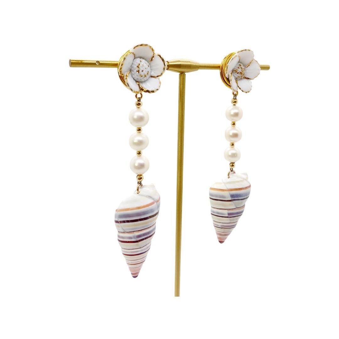 This is for a pair of earrings. Inspired by the ocean, by the cool summer breeze and for that tropical vacays we all want to take. A vintage multi-pastel color shell is the heart of the earring complimented by vintage handmade porcelain flower from