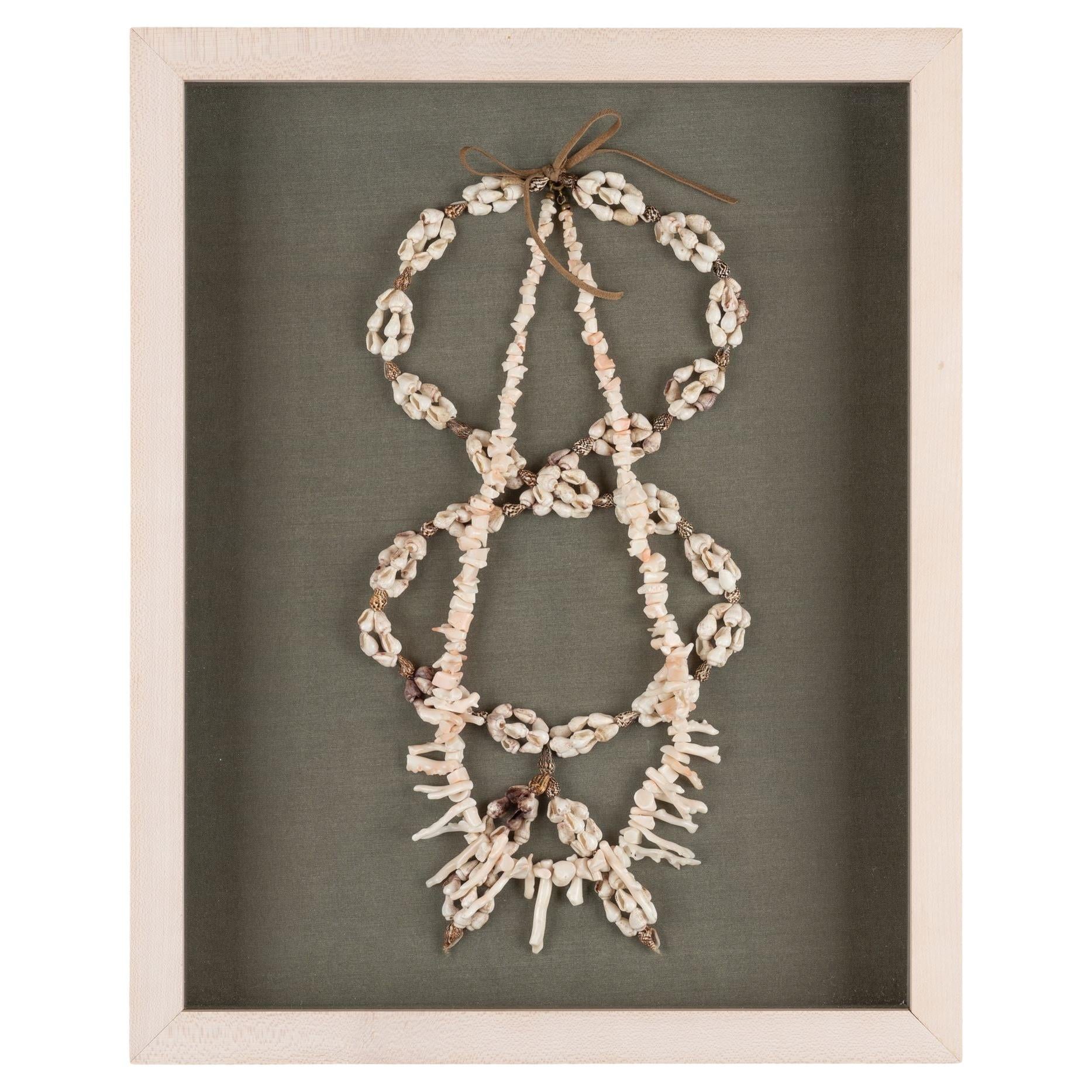 Shell and white branch coral necklaces mounted in a custom shadowbox