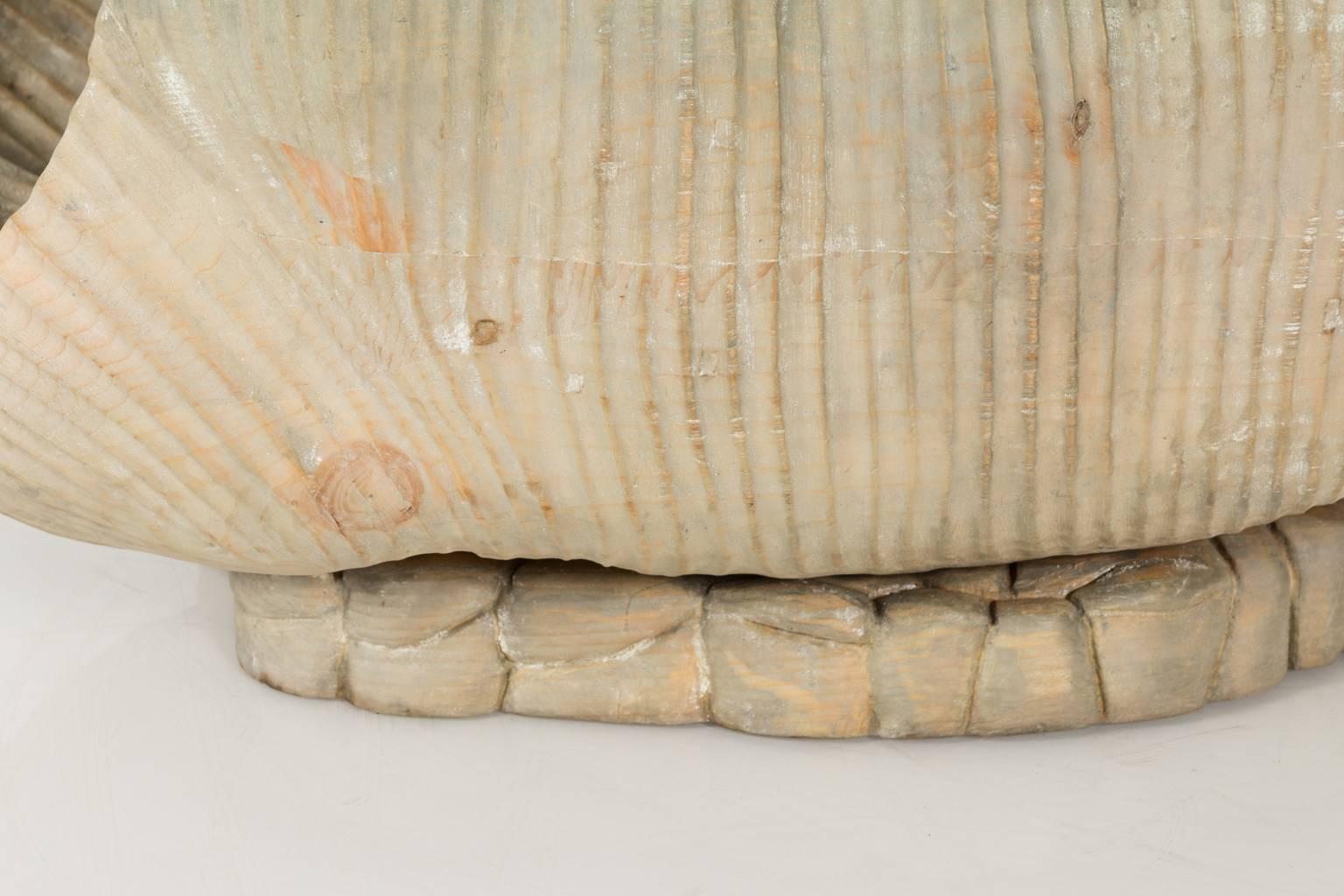 An Italian carved and cerused shell based coffee table with a glass top.
 