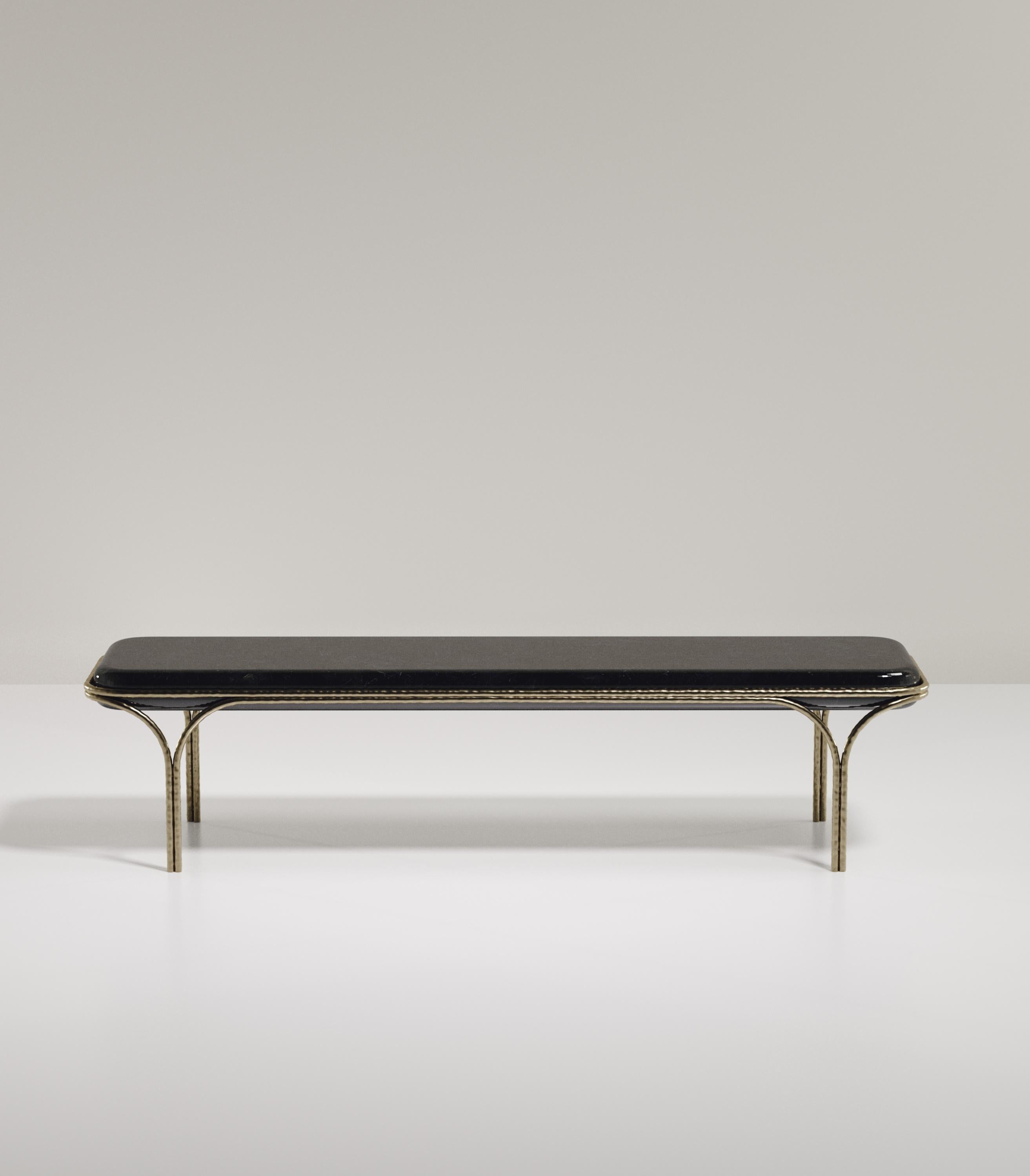 The Arianne bench by R&Y Augousti is an elegant piece for any space. The black pen shell inlaid seat, with curved edges, sits on an organic bronze-patina frame. The intricate frame and legs have a 