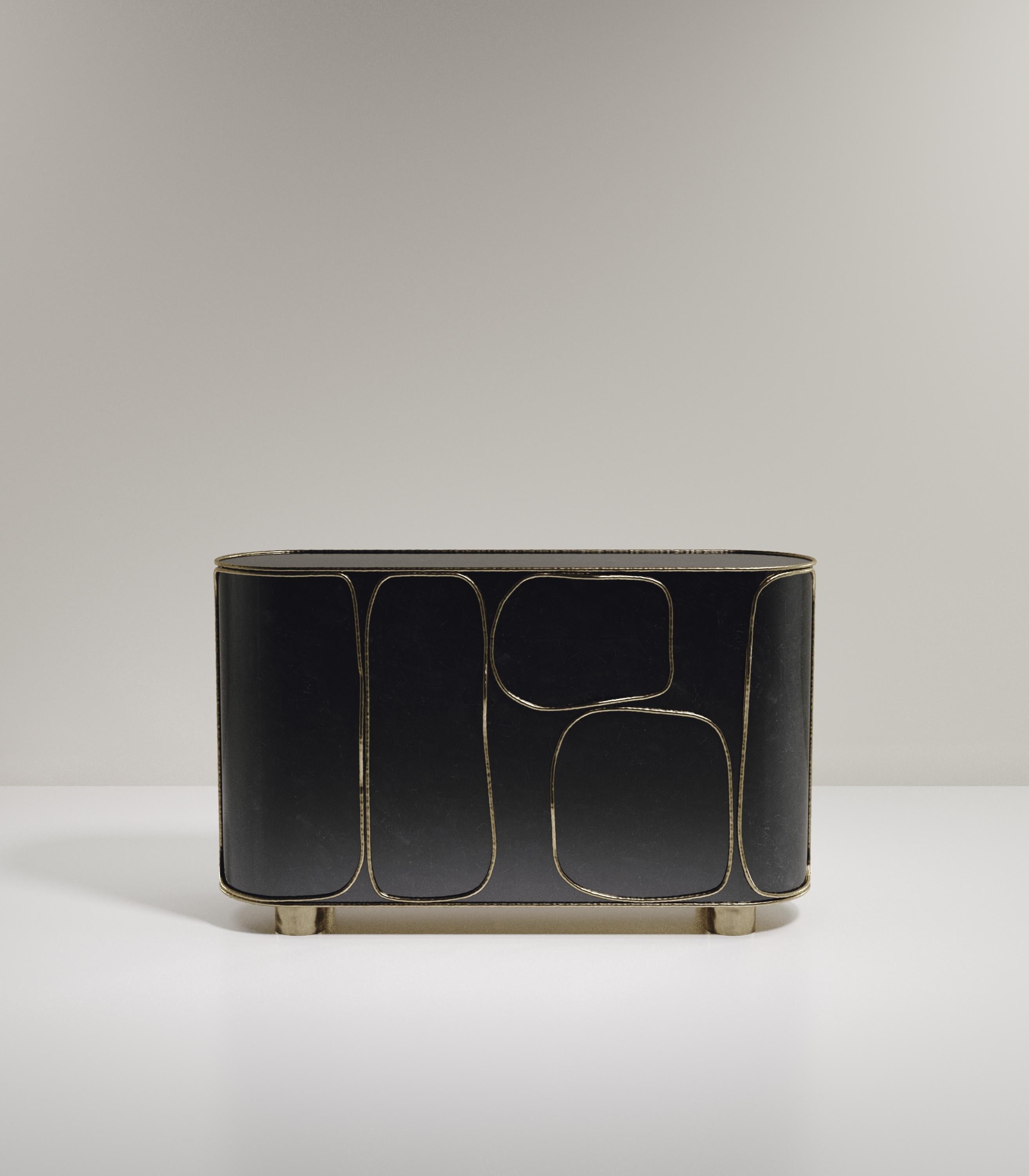 The Arianne buffet by R&Y Augousti is one of a kind statement piece. The overall piece is inlaid in black pen shell accentuated with intricate bronze-patina brass details that have the signature Augousti 