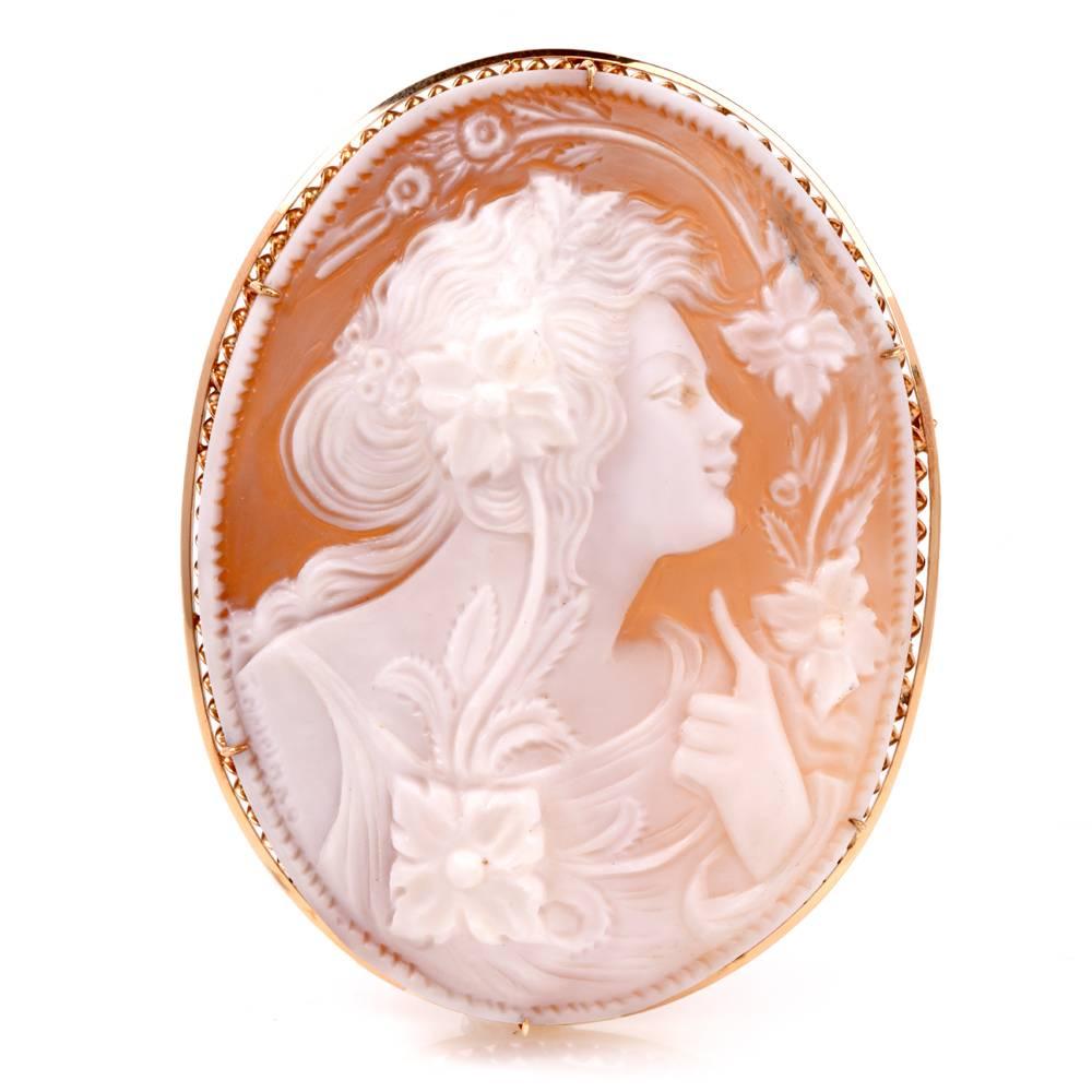 This versatile handmade cameo brooch and pendant depicts the artfully relief carved of an attractive female portrait with classic Roman attire and hair ornaments. The masterfully carved shell portrait is surrounded by delicate floral motif profiles