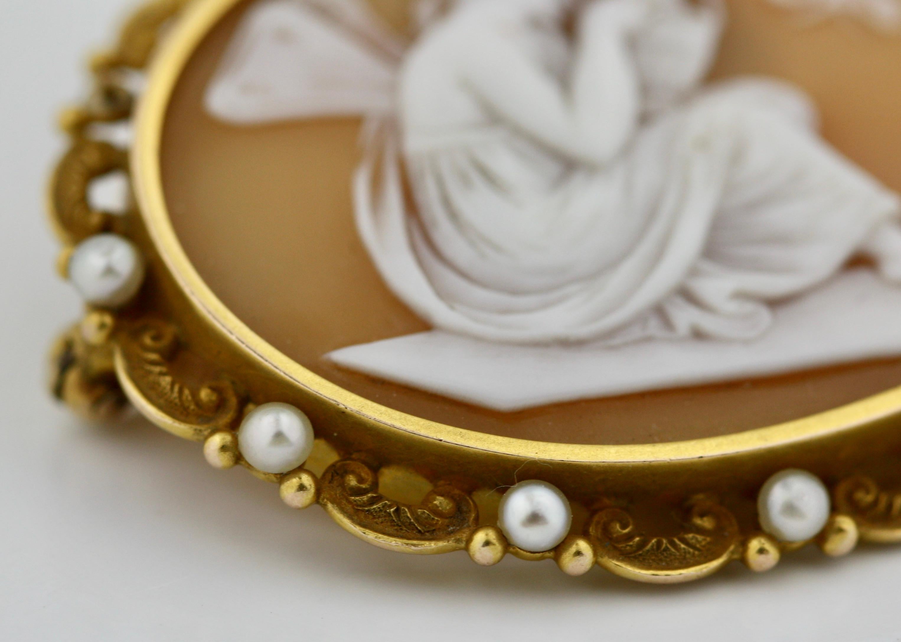 
Shell cameo brooch
Depicting a young nymph, surrounded by gold and 11 seed pearls one missing, measuring approximately 42 x 35mm, French import assay mark for 18 karat gold, gross weight 9.41 grams