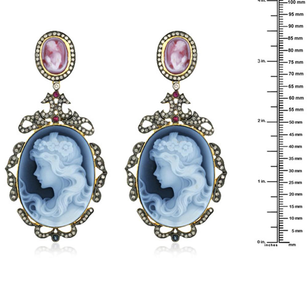 Angelic this Shell Cameo Diamond Drop Earrings in Silver and 18K Gold is sweet.

Closure: Push Post

18kt Gold: 7.03gms
Diamond: 2.84cts
Shell Cameos: 90Cts
Ruby: 0.5Cts
Blue Sapphire: 0.5Cts
