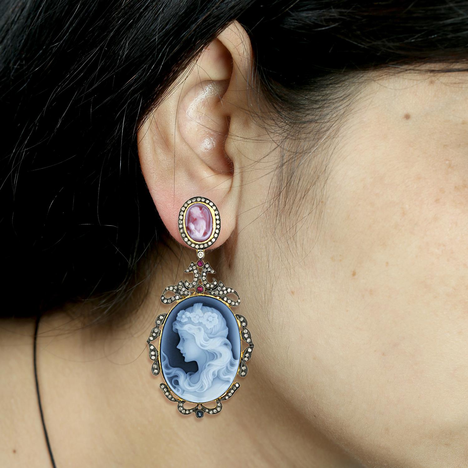 Angelic this Shell Cameo Diamond Drop Earrings in Silver and 18K Gold is sweet.

Closure: Push Post

18kt Gold: 7.03gms
Diamond: 2.84cts
Shell Cameos: 90Cts
Ruby: 0.5Cts
Blue Sapphire: 0.5Cts
