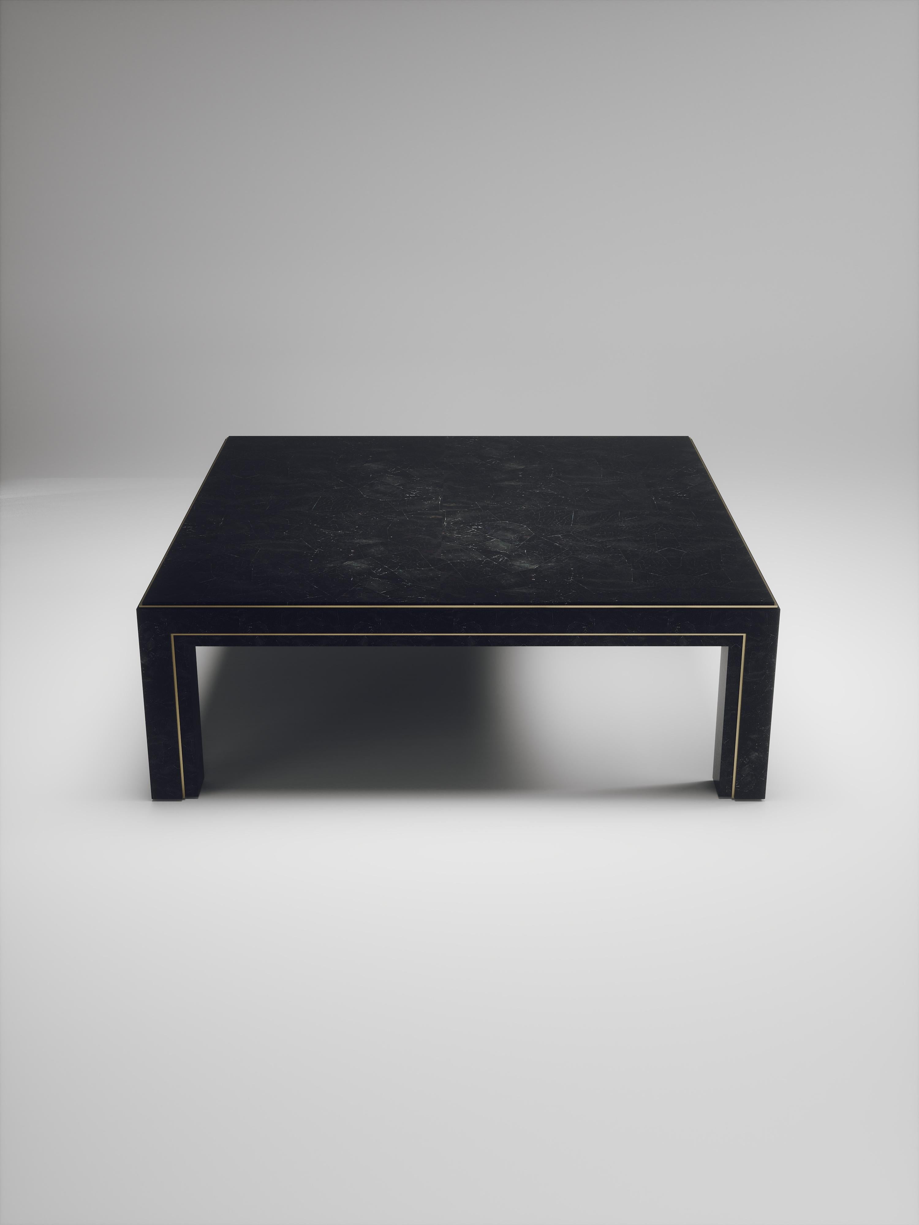 The Parsons coffee table by R&Y Augousti is classic and elegant staple piece for your home. The clean lines of the overall piece, inlaid in black pen shell, are accentuated by the discreet bronze-patina brass indentation detail giving it a luxurious