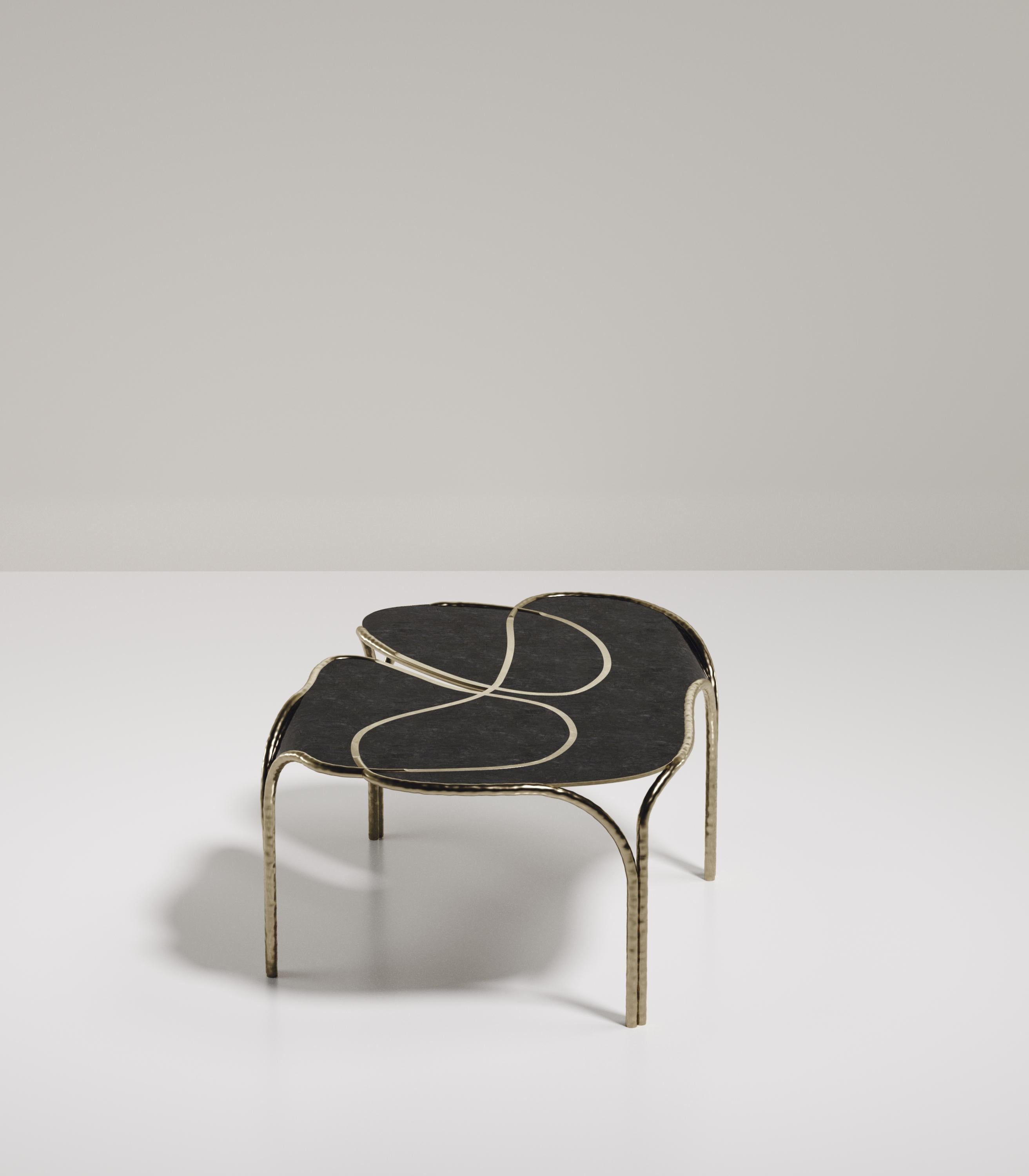 The Arianne coffee table by R&Y Augousti is one of a kind statement and whimsical piece. The overall piece is inlaid in black pen shell accentuated with intricate bronze-patina brass details that have the signature Augousti 