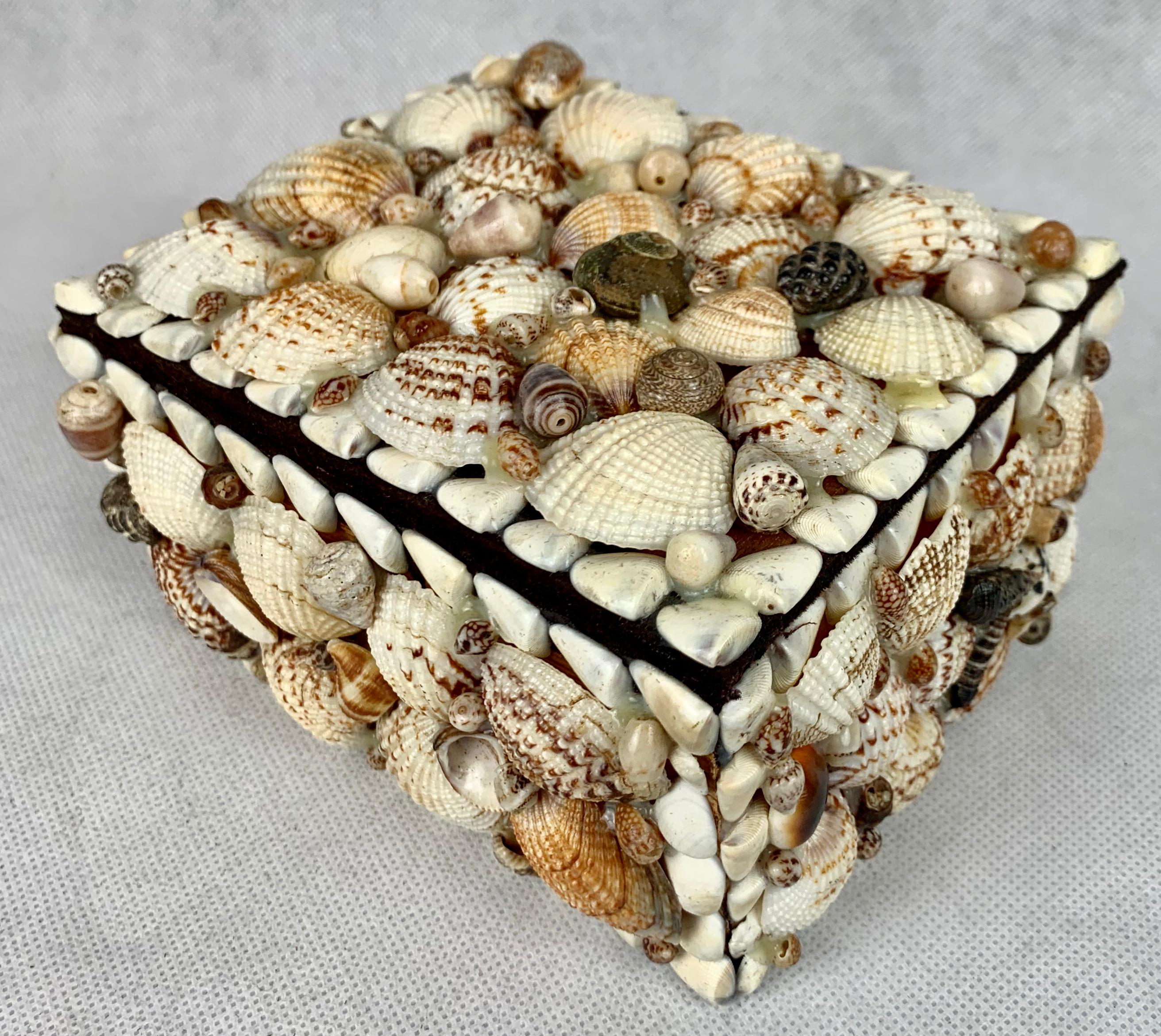 Beautifully hand decorated box covered with sea shells. The box is lined in brown velvet. There is minor damage to the edges of several shells (see photos) which doesn't impact on the use of the box. This box could be used for jewelry or just as
