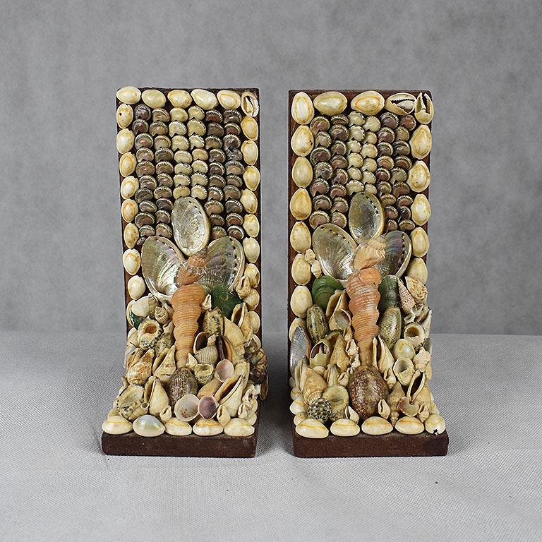 Set of two shell encrusted bookends. Created out of a lovely mixture of different kinds of shells, this lovely pair will add a beautiful addition to any bookshelf. 

Measures: 3.5