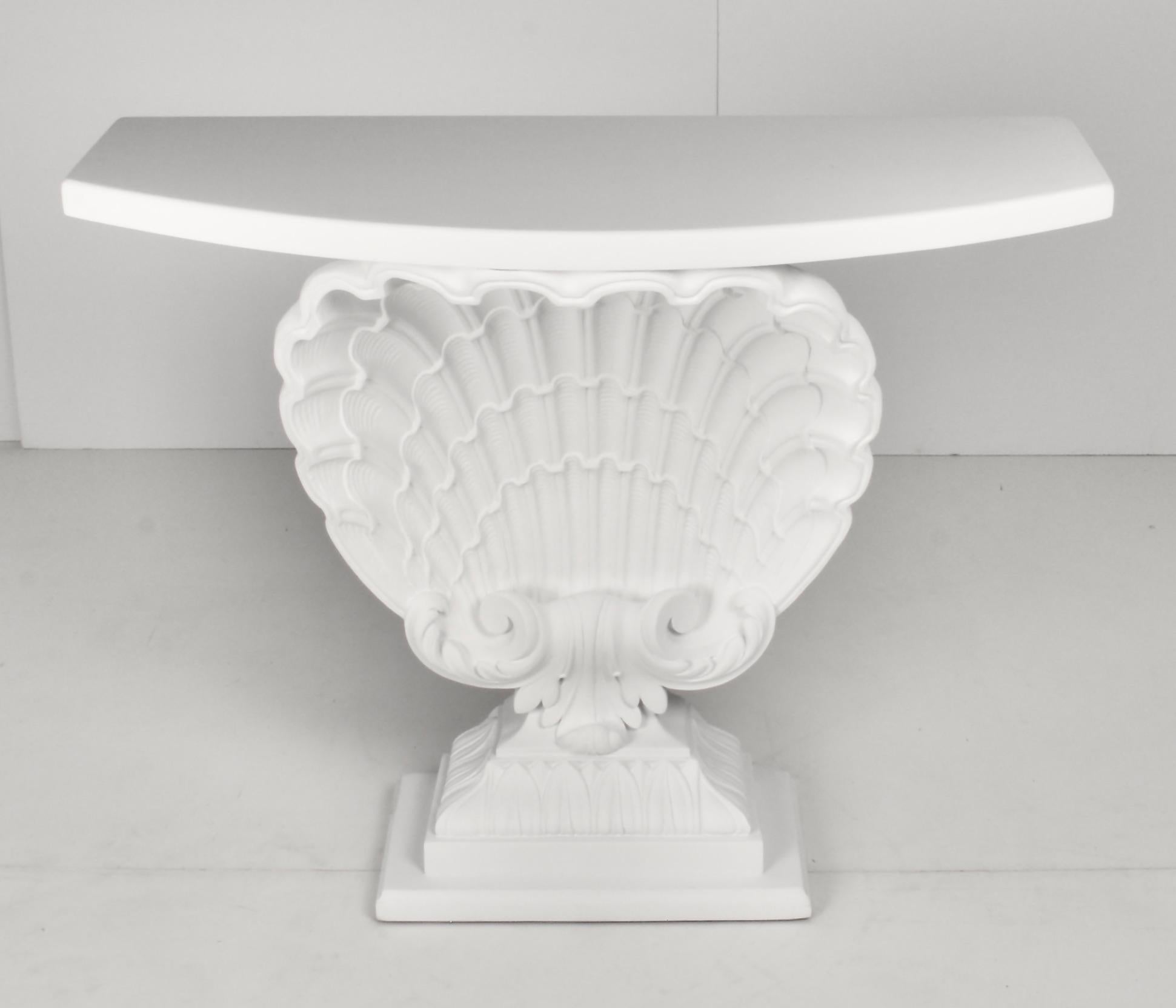 A beautifully restored, classic Hollywood Regency shell-form console by Grosfeld House. Newly painted in plaster white with a super flat finish. Excellent condition.