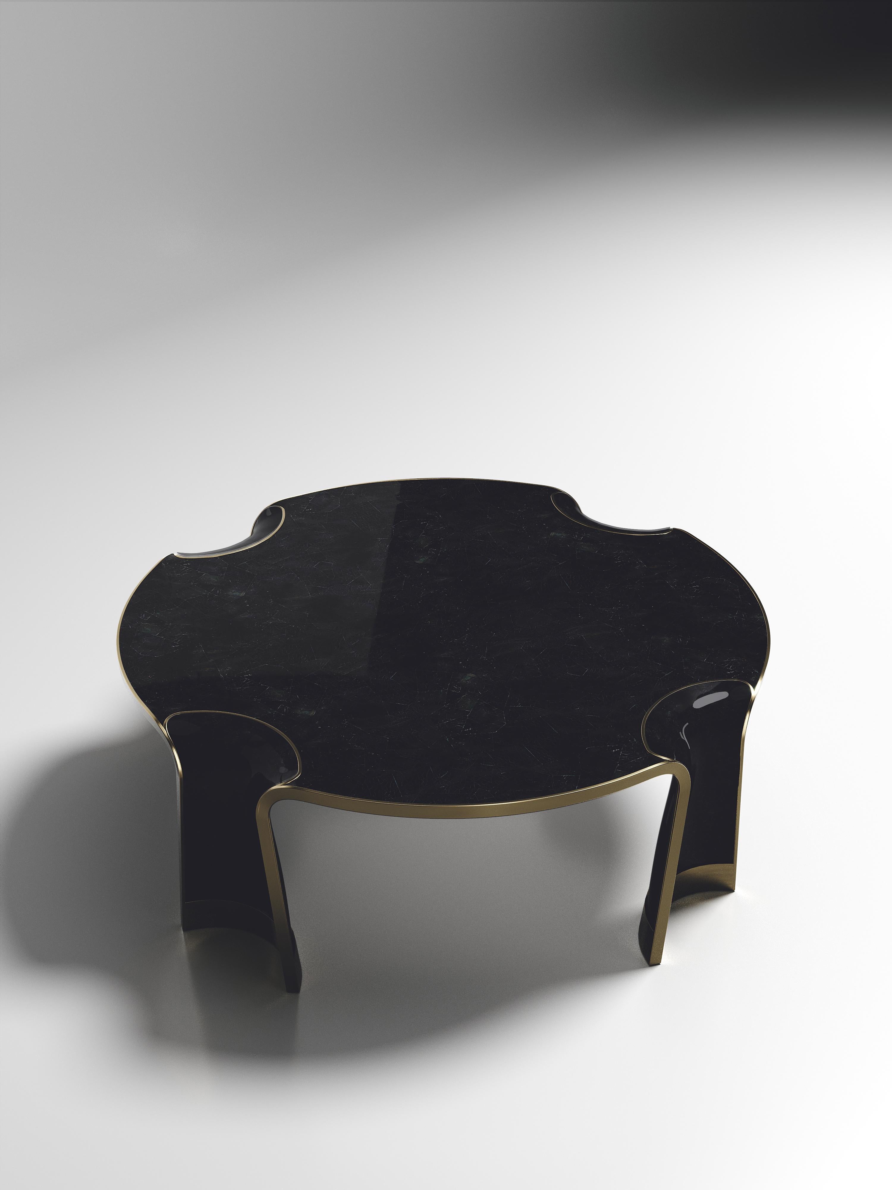 The Nymphea round coffee by R & Y Augousti in pen shell with bronze-patina brass details explores the brand's iconic DNA of bringing old world artisanal craft into a contemporary and utterly luxury feel. This table is done in a black pen shell