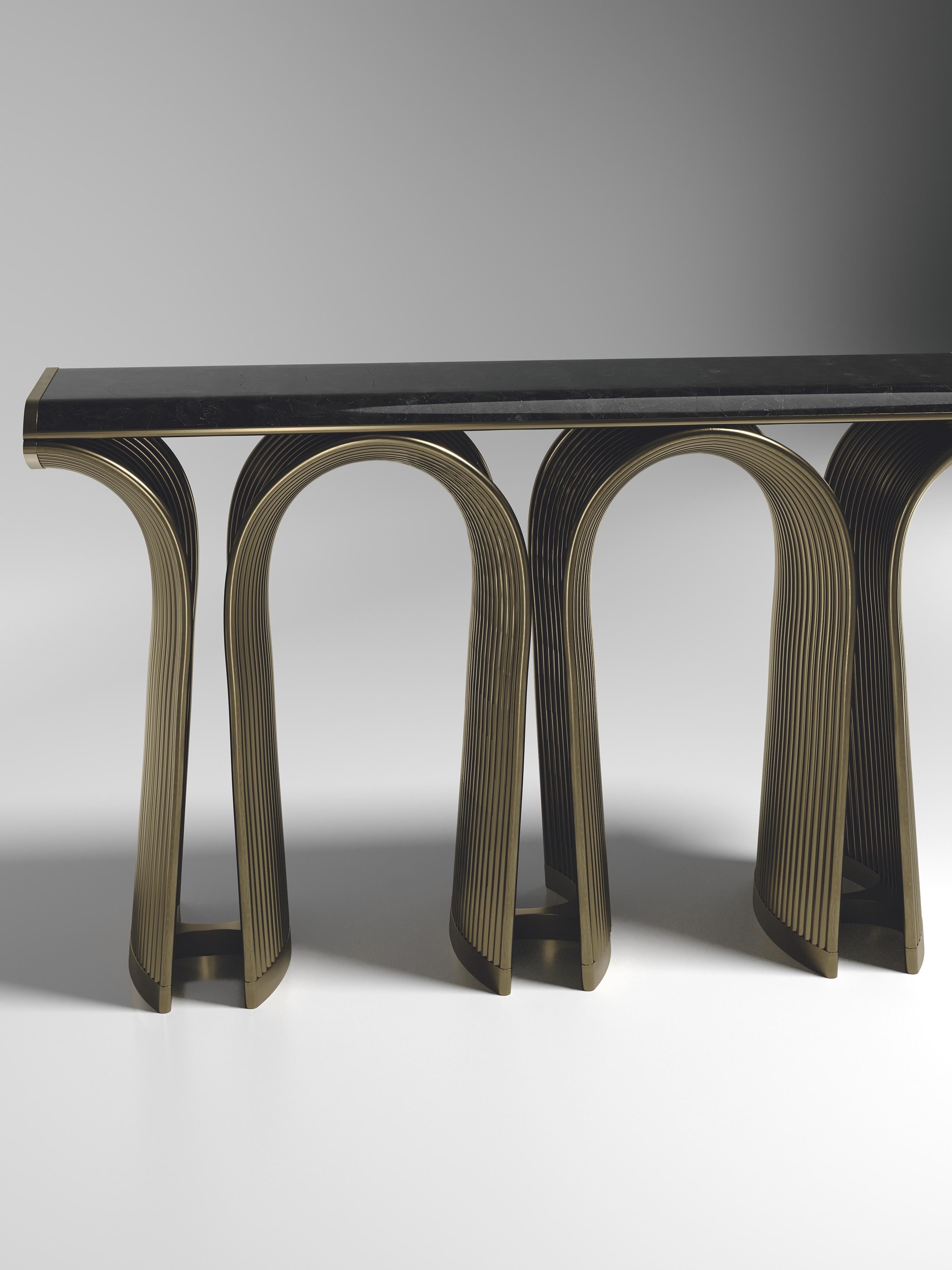 The Nymphea console by R&Y Augousti in black pen shell with bronze-patina brass details explores the brand's iconic DNA of bringing old world artisanal craft into a contemporary and utterly luxury feel. The base of the console is handcrafted with