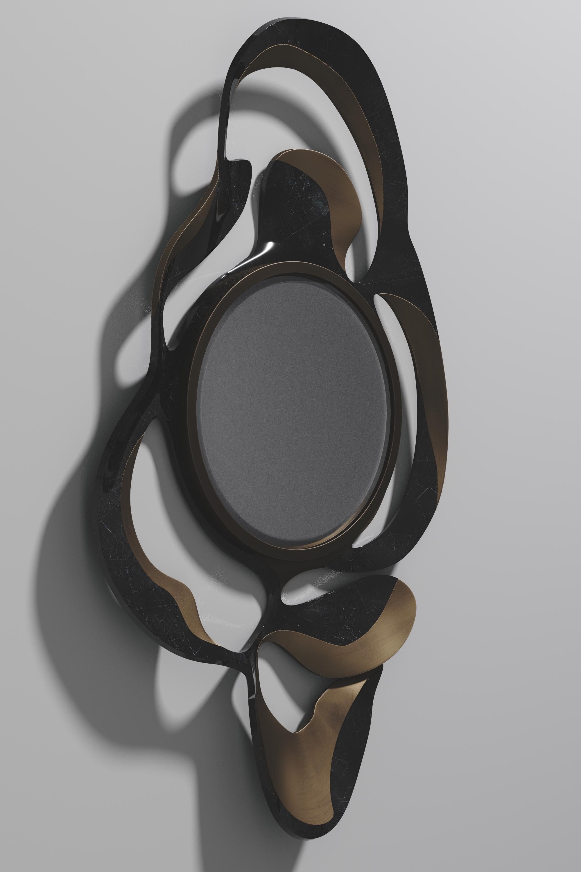 The Leaf Mirror by Kifu Paris is a dramatic and organic piece. The black pen shell and bronze-patina bass inlay mixture creates a striking appearance as it emulates a whimsical interpretation of intertwining branches. This piece is designed by Kifu
