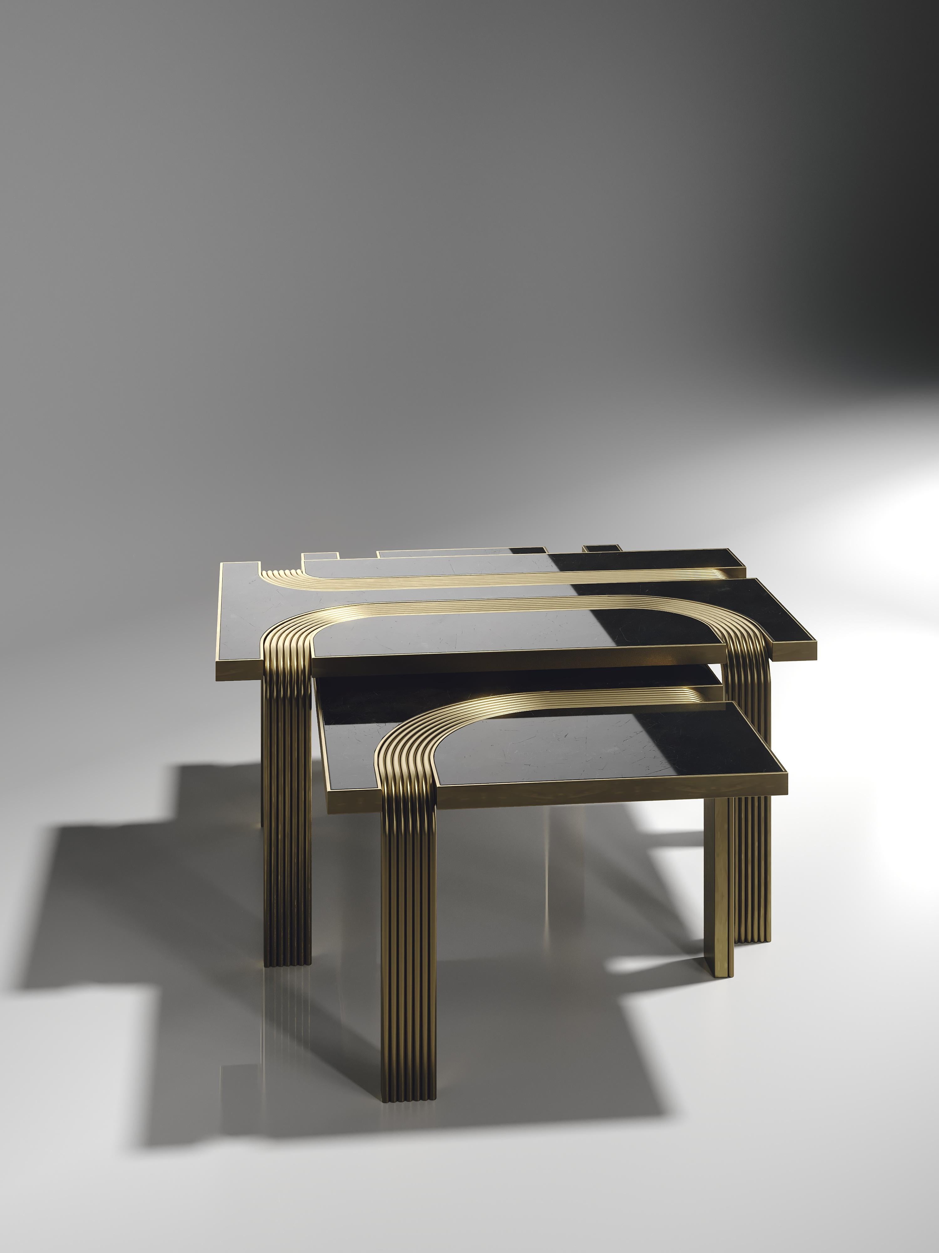 The Set of 2 Licol nesting coffee tables by R & Y Augousti in black pen shemm with bronze-patina brass details explore the brand's iconic DNA of bringing old world artisanal craft into a contemporary and utterly luxury feel. These tables nest