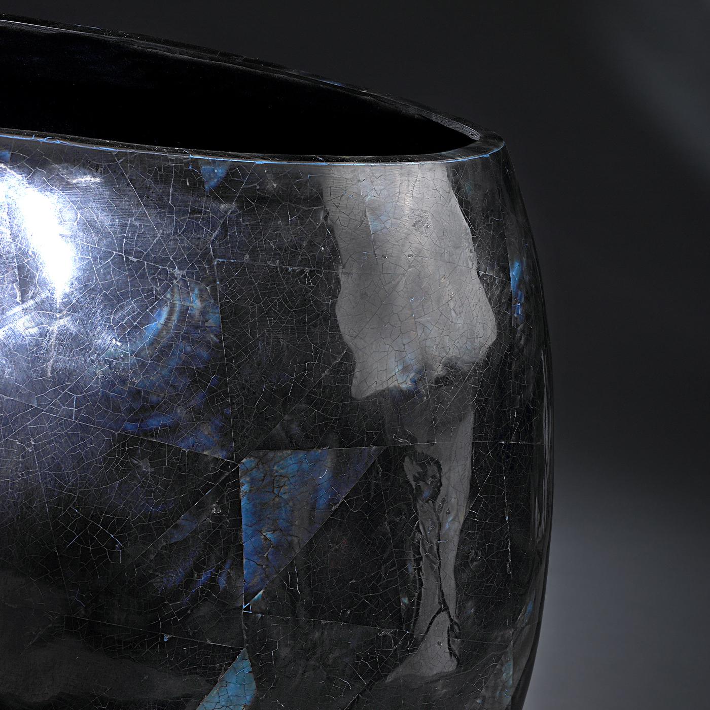 A superb addition to a contemporary decor, this vase is distinguished for its generous-sized silhouette marked by the unique signs of craftsmanship. Exquisitely fashioned of glass boasting a polished dark blue tone, this piece features a striking